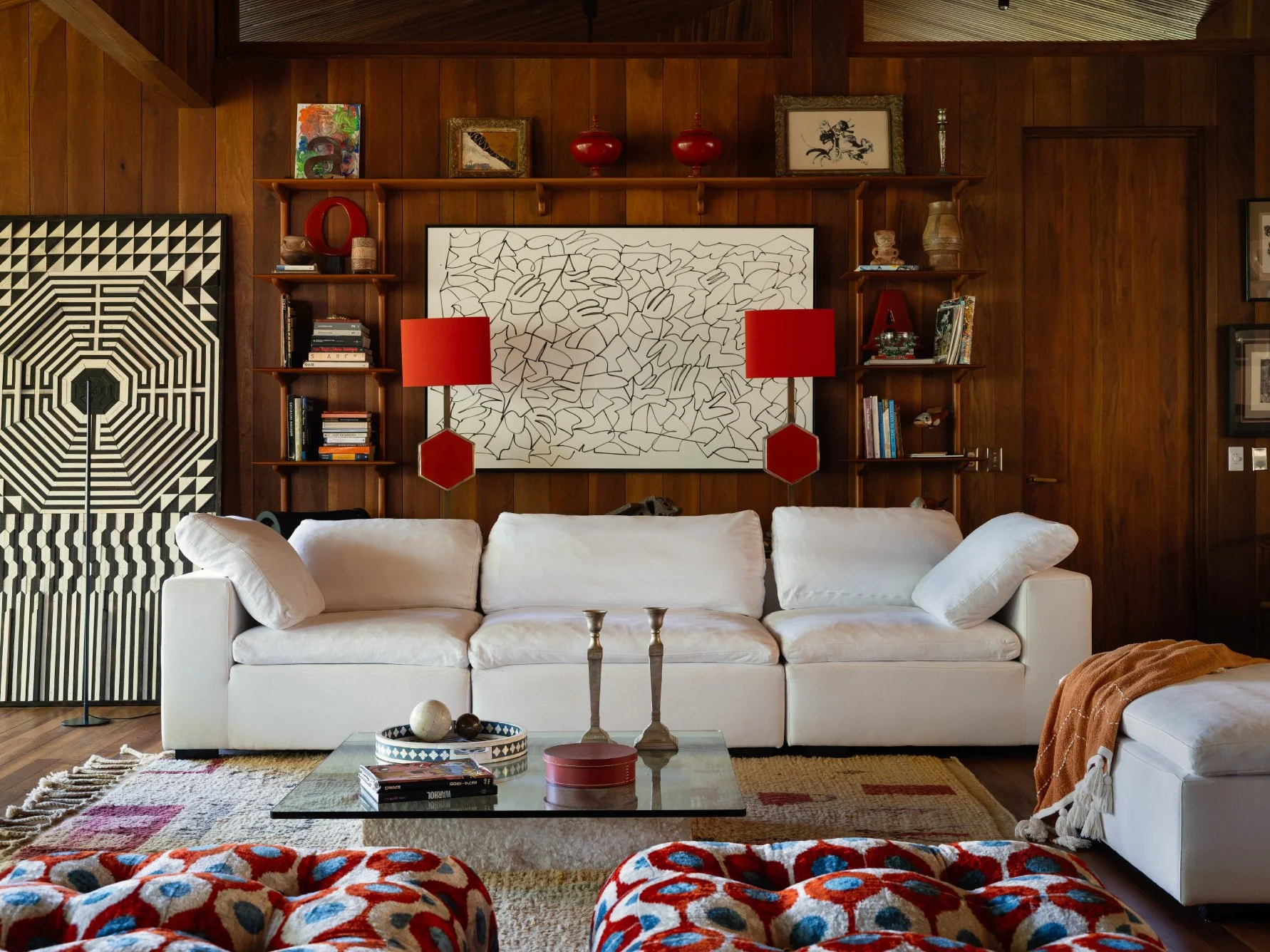 Al Suave House living room in Santa Teresa, Costa Rica, with built-in timber shelving and red lamps, FAMM Arquitectura
