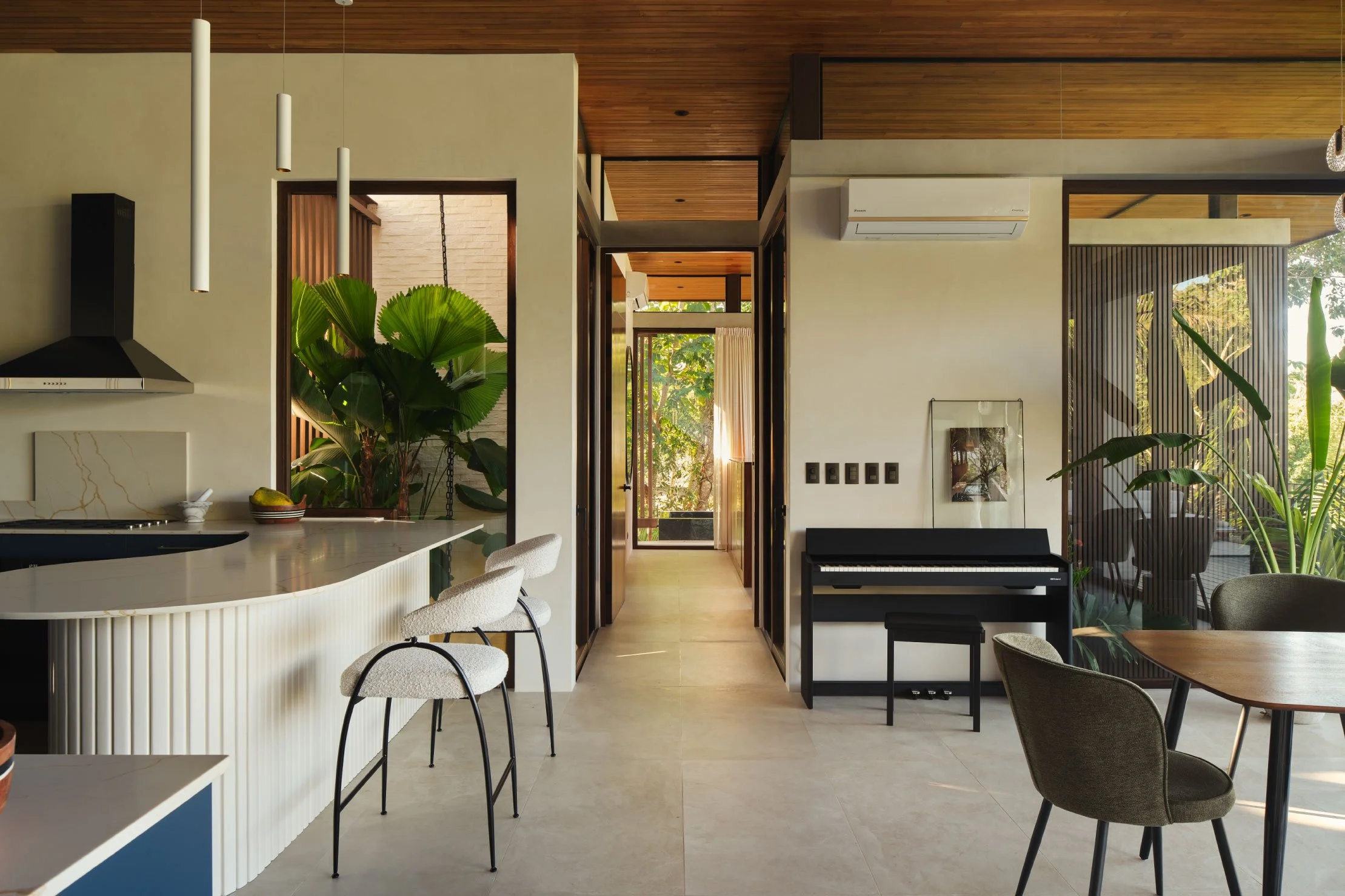 Minibauta House dining room in Santa Teresa, Costa Rica, with timber ceiling, grey chairs and garden views, by FAMM Arquitectura