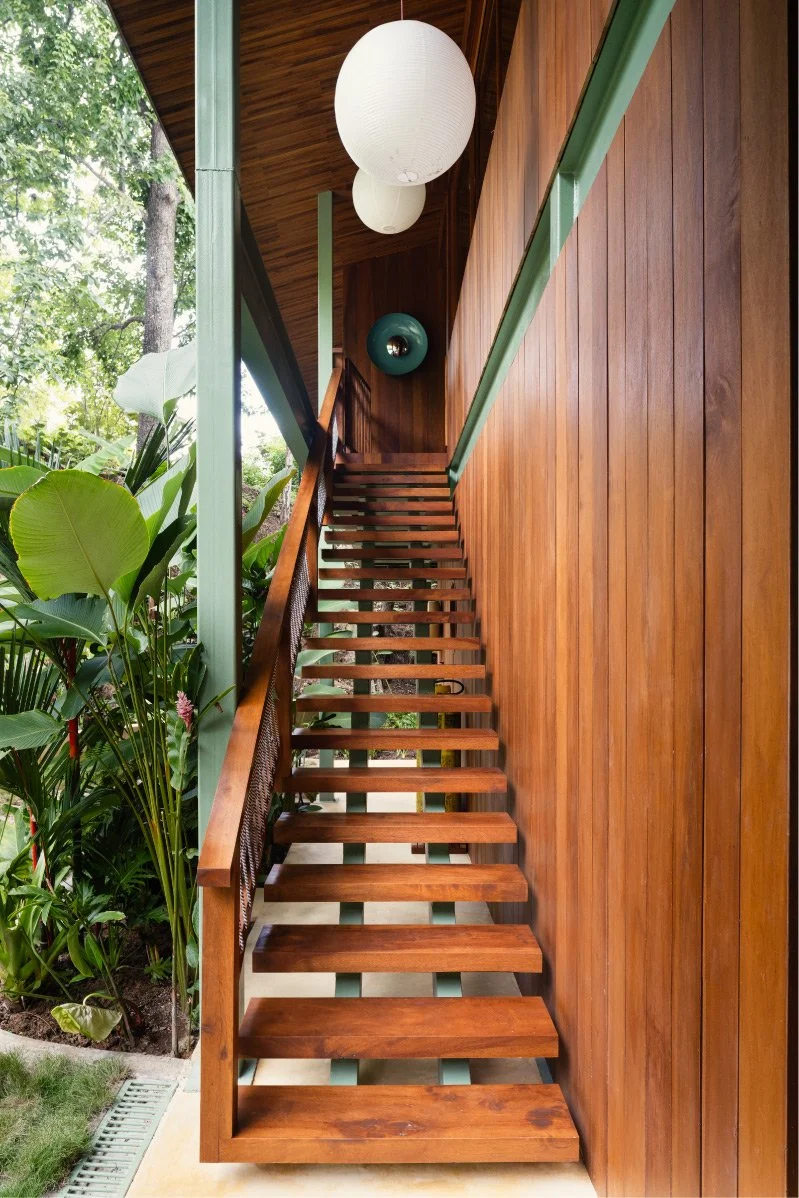 Al Suave House timber staircase in Santa Teresa, Costa Rica, beside a garden view, FAMM Arquitectura