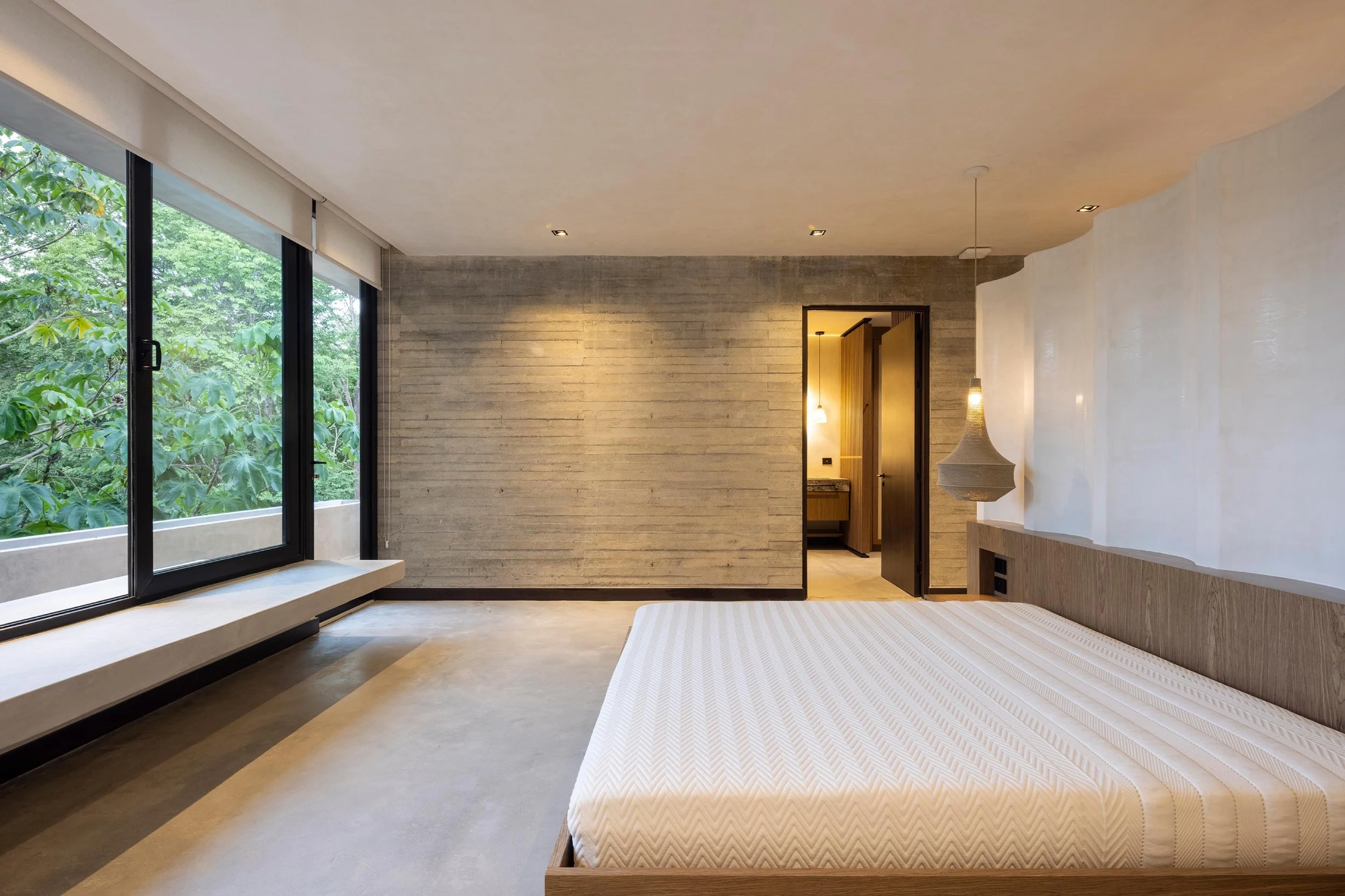 Casa Jungla bedroom in Santa Teresa, Costa Rica, with floor-to-ceiling windows onto the forest, by FAMM Arquitectura