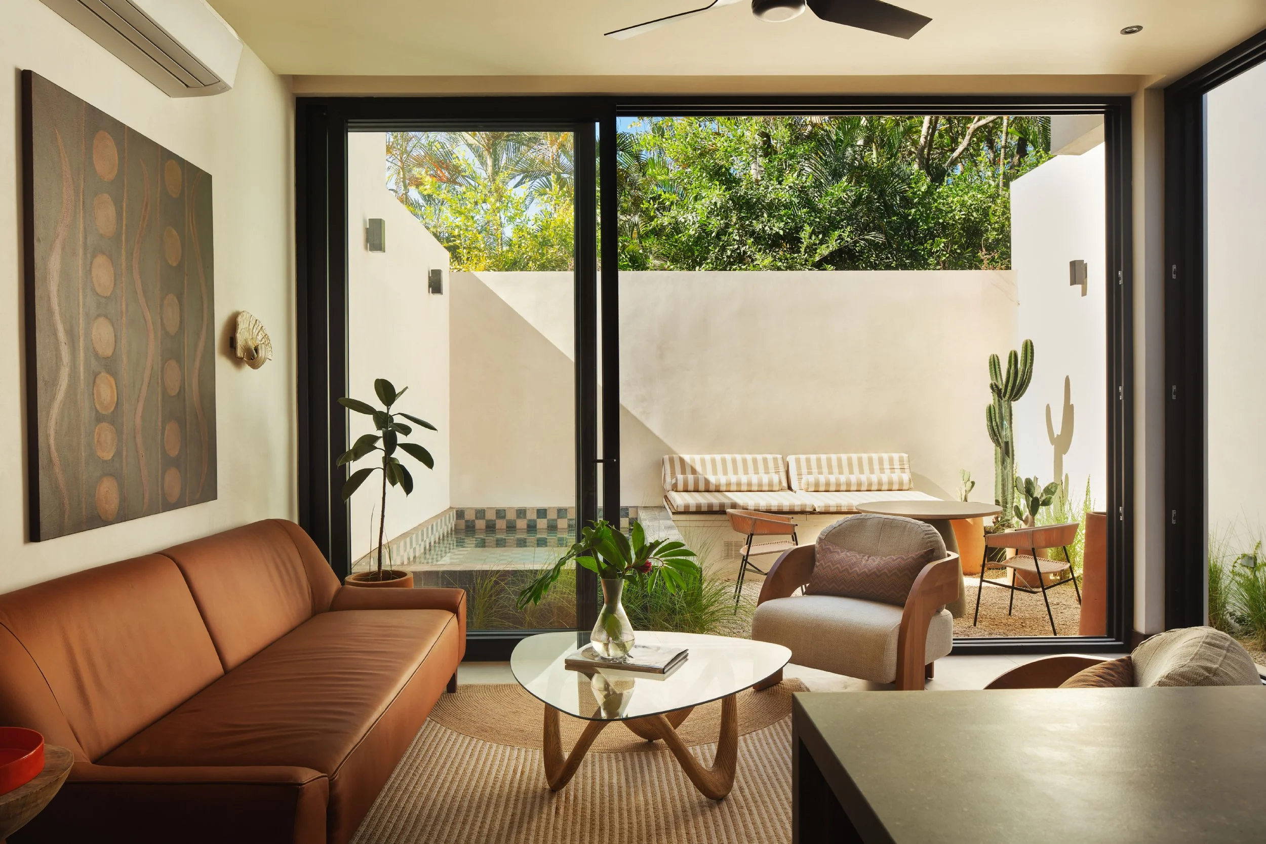 El Molino interior in Nosara, Costa Rica, with sheer curtain, timber panel and clay planter, by FAMM Arquitectura