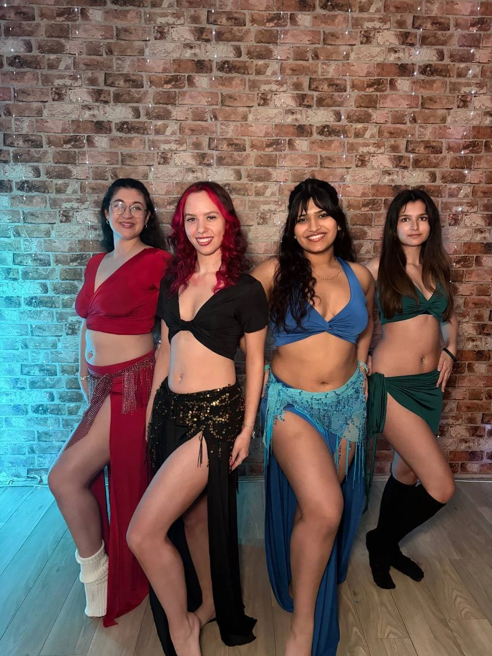 Four women wearing a collection of our belly dance training clothes