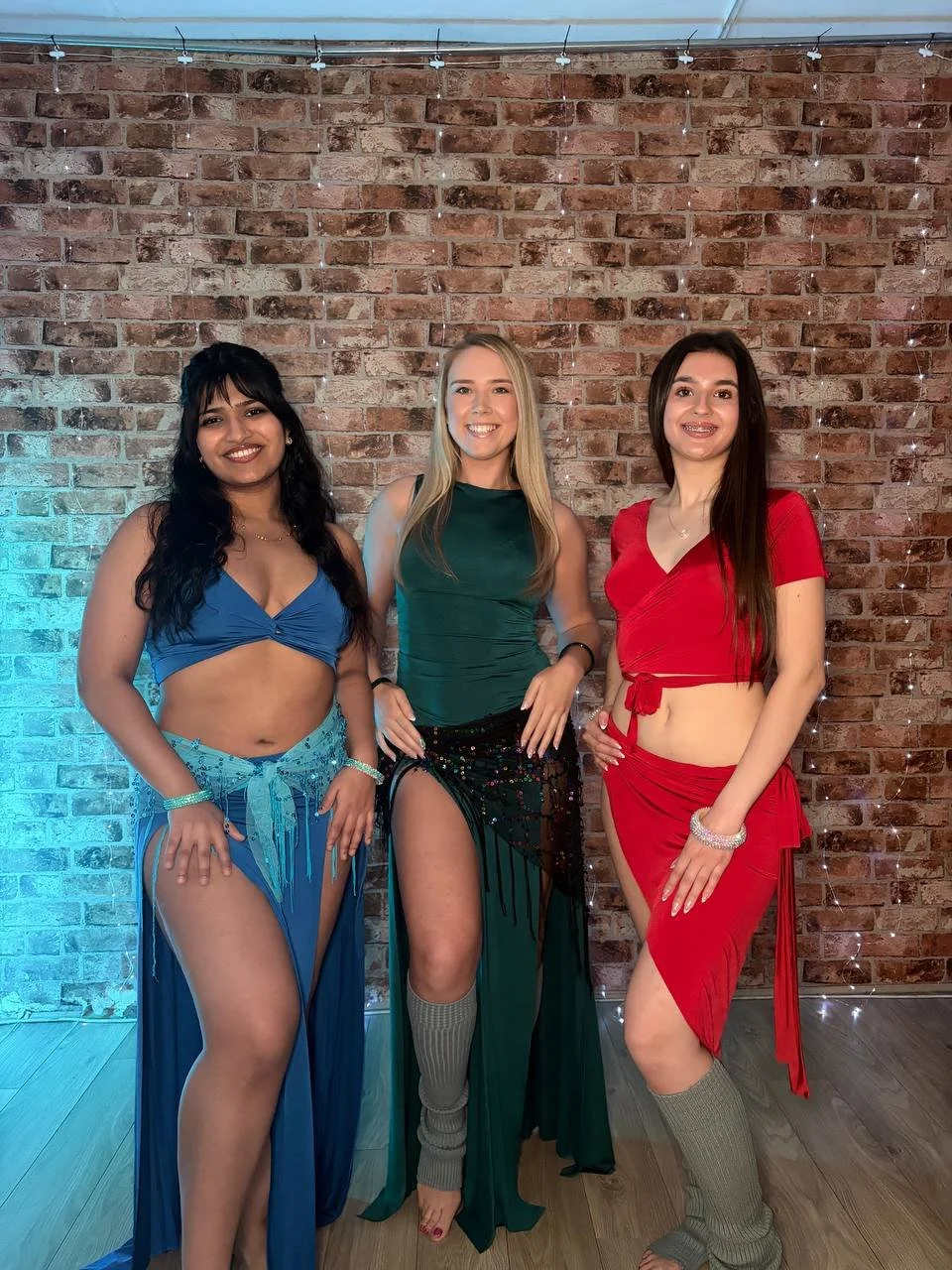 Three women wearing a collection of our belly dance training clothes