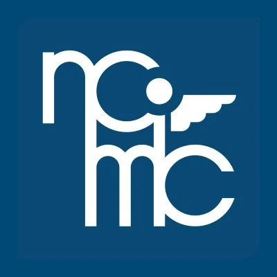 The logo of NC MICC with stylized letters and a winged element on a dark blue background.