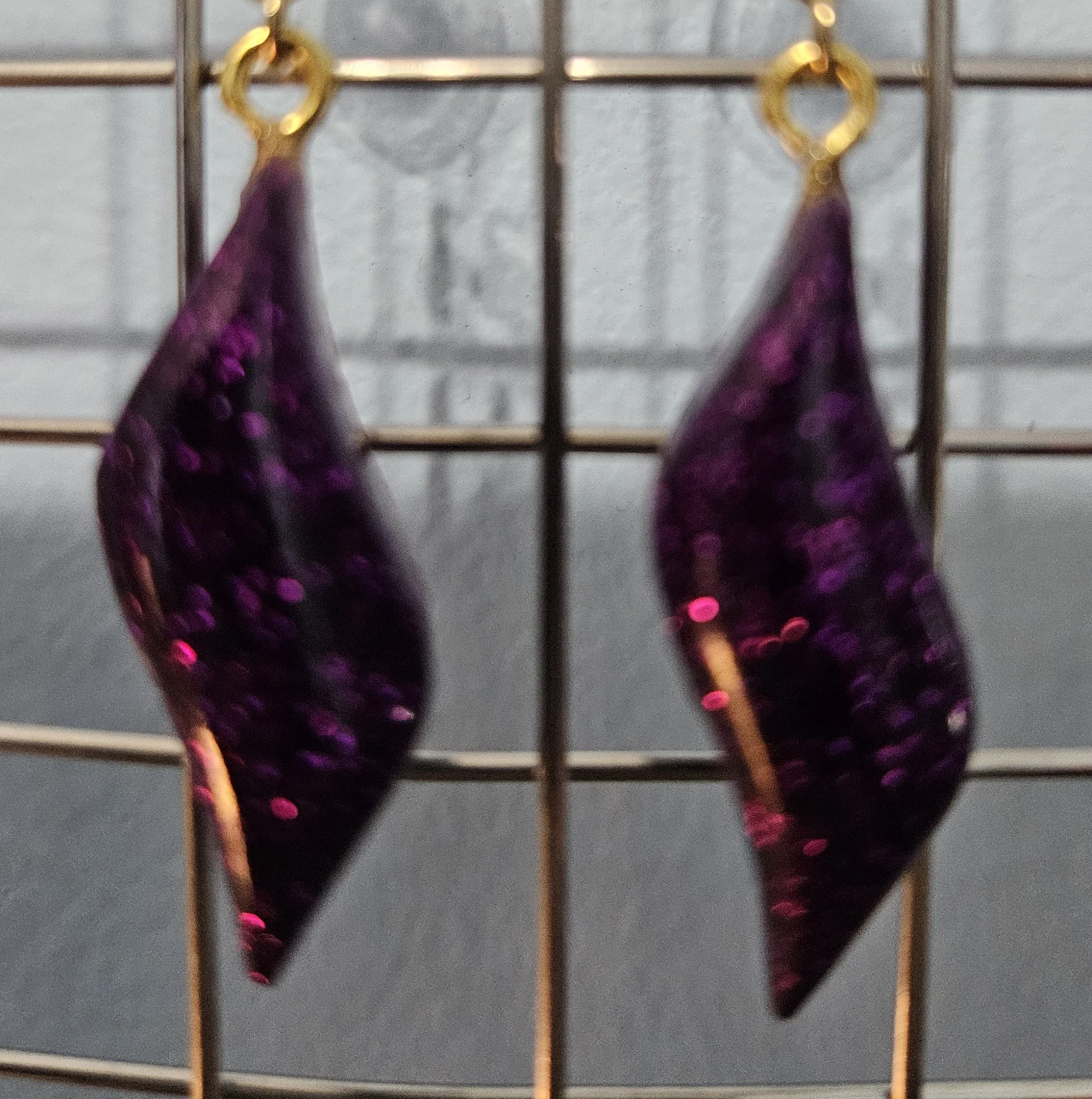 Fine deep purple glitter encased in clear hard resin.