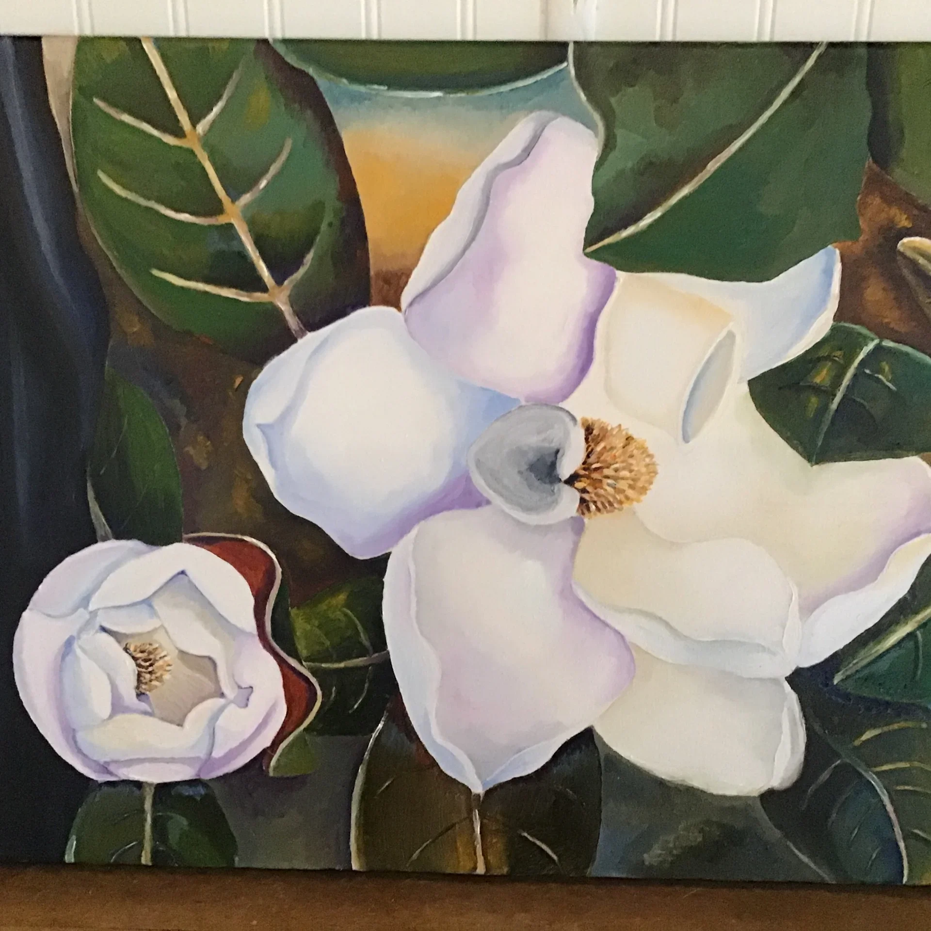A painting of white magnolia flowers with green leaves and a background with warm tones.