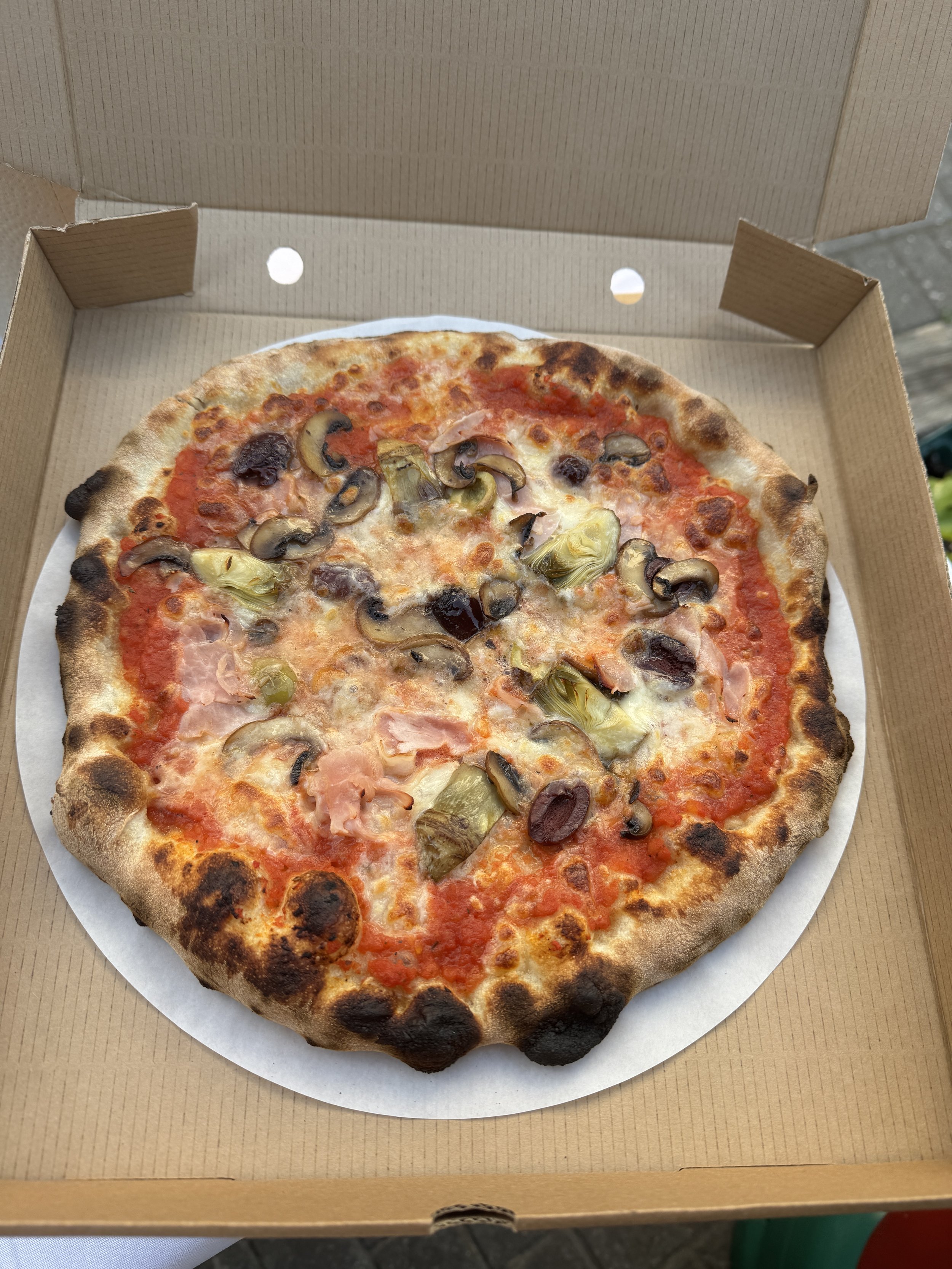 A sliced mushroom pizza in a cardboard pizza box.