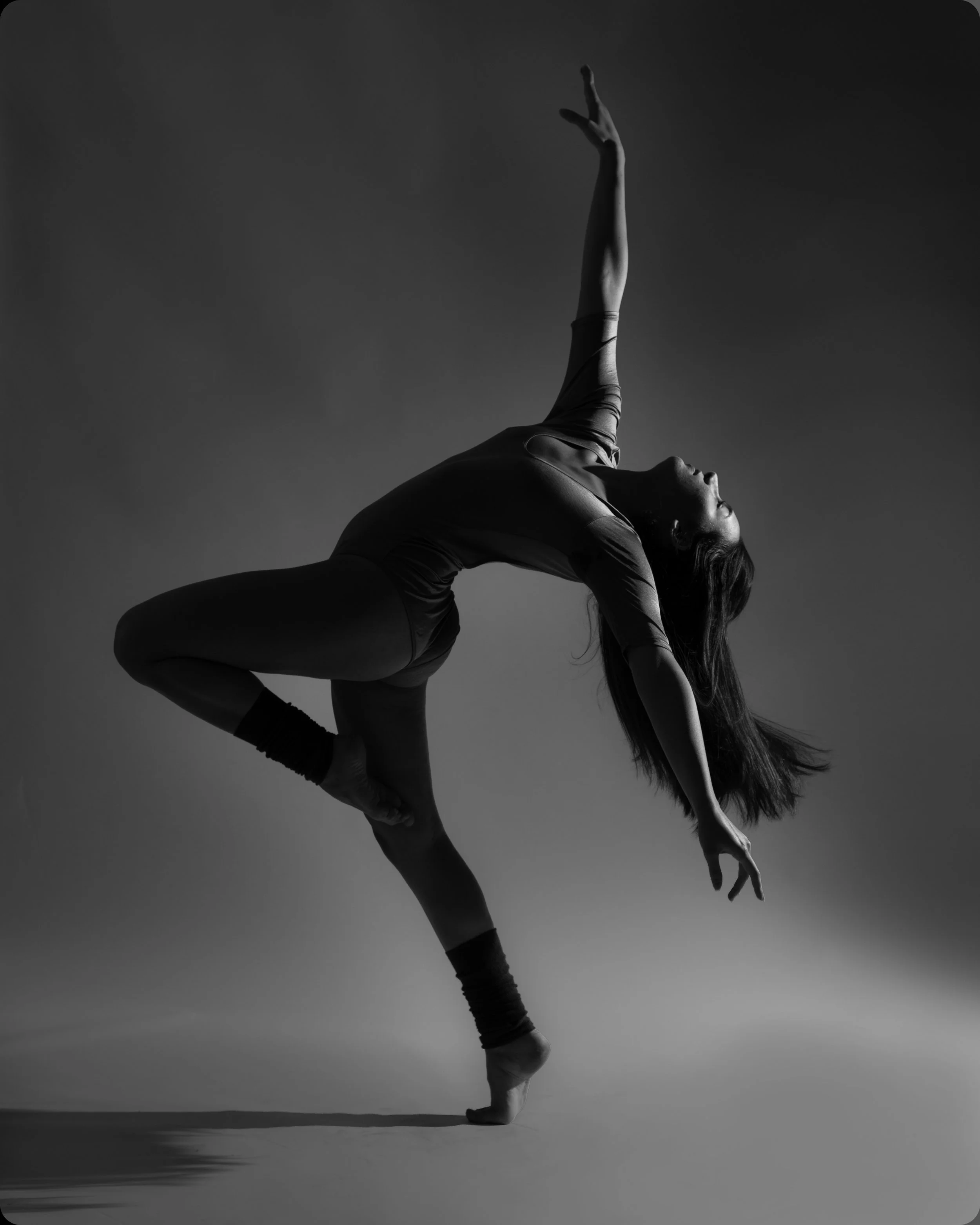 Black and white photo of woman posing in a backbend