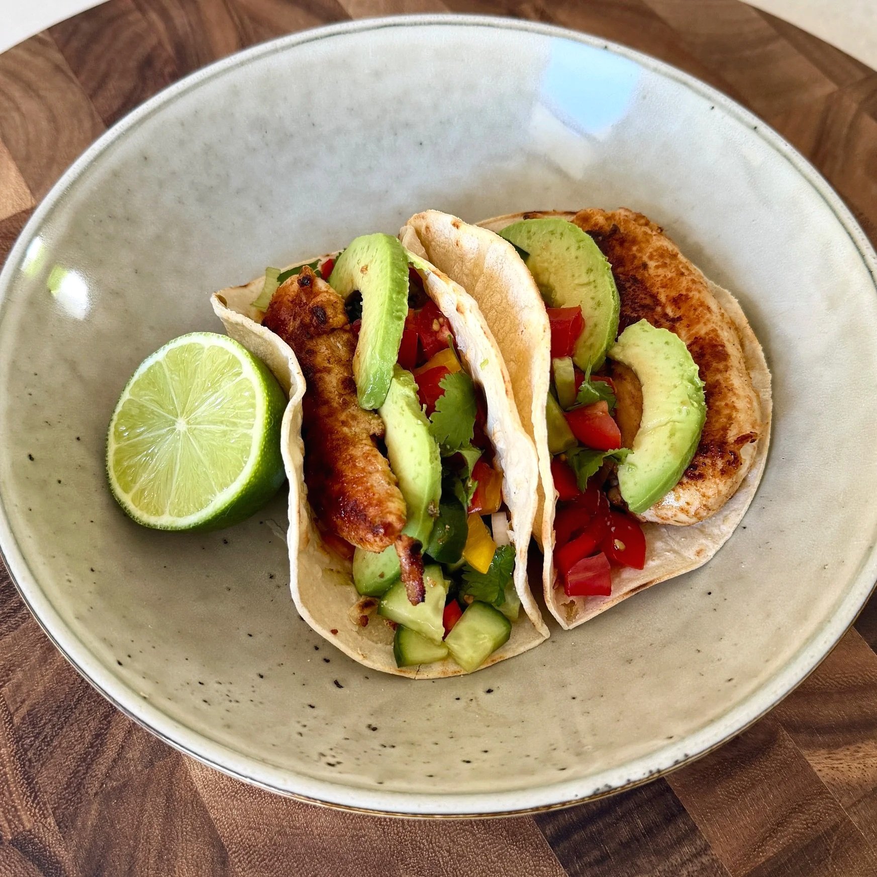 Clean and simple chicken tacos with fresh salsa and avocado served on soft tortillas, bright and fresh.