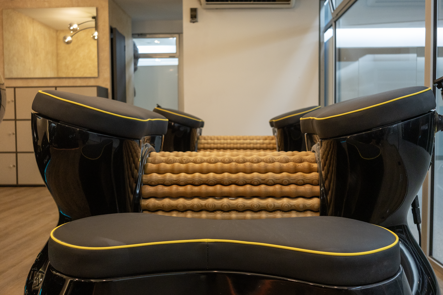 Scenic view of snow-capped mountains in the background, rolling green hills in the foreground, and modern building structures on the hill