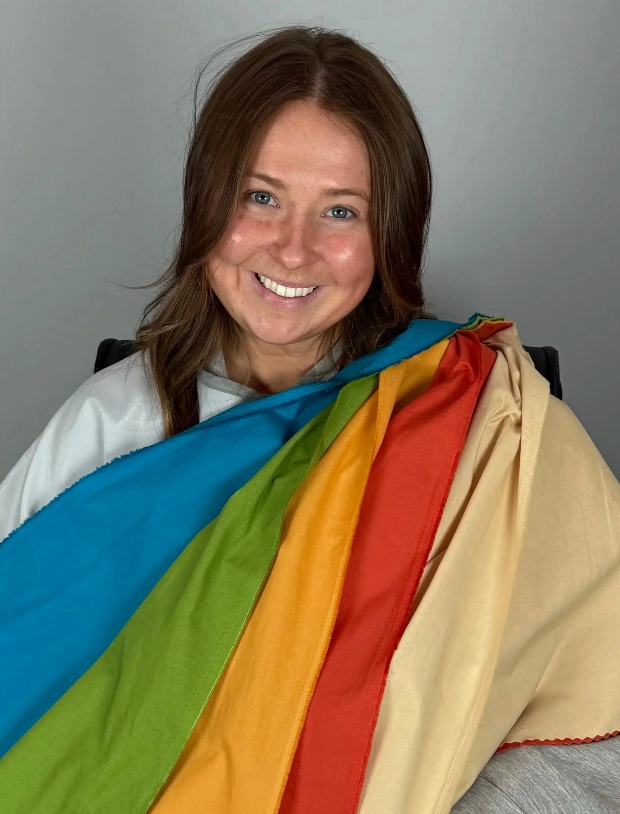 Young woman with reddish brown hair smiling after her color analysis