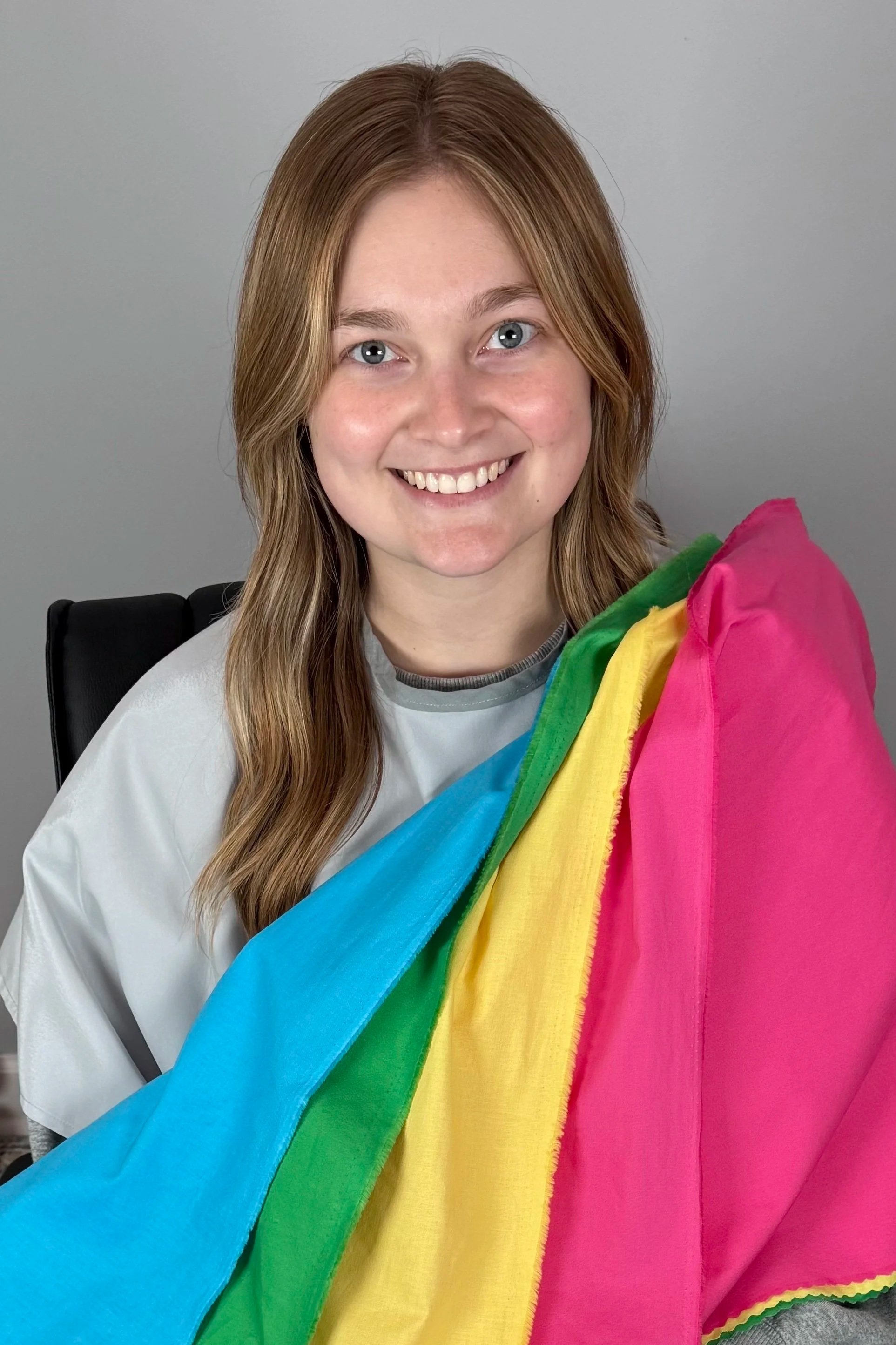 Young woman with blonde brown hair smiling after her color analysis