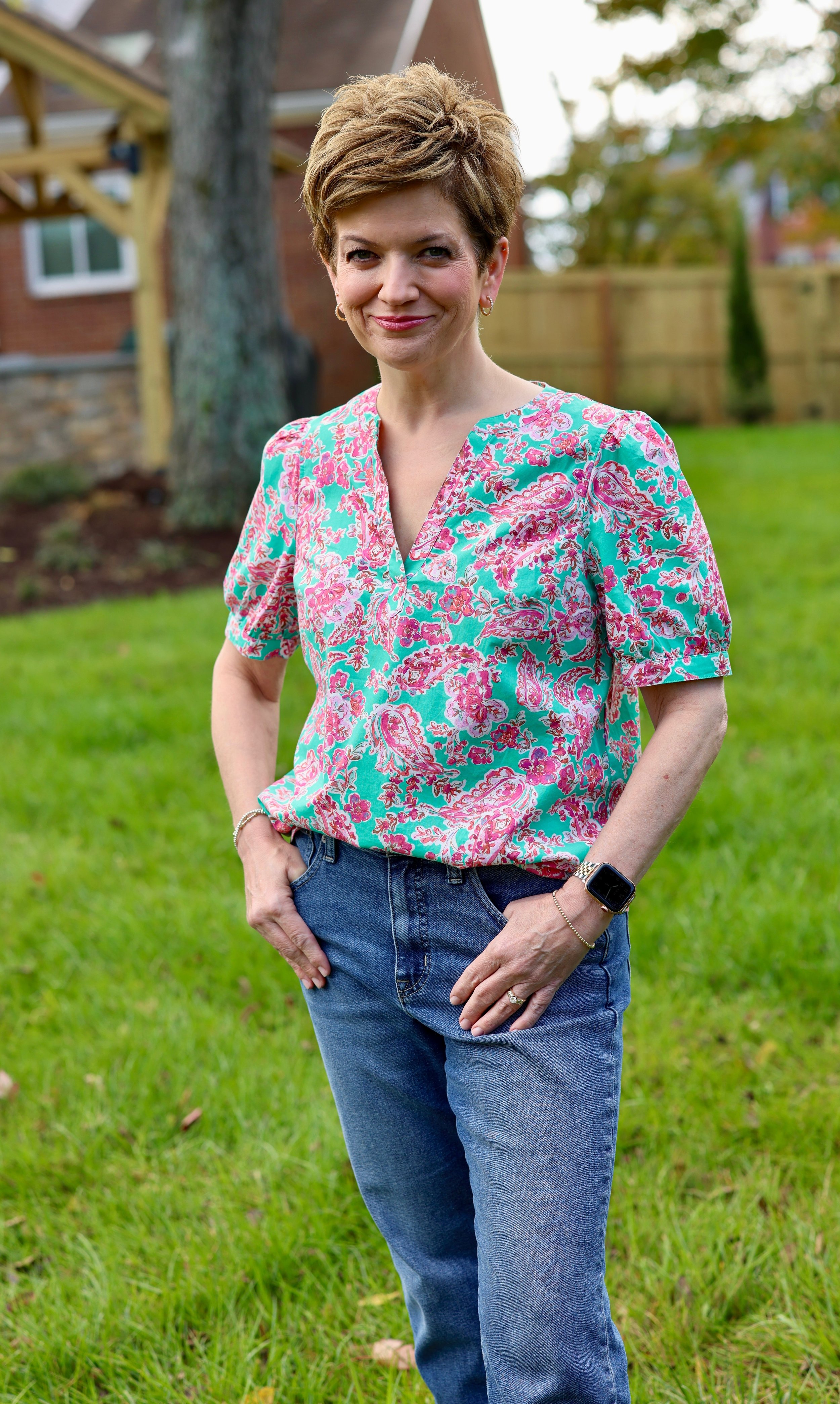 Liz in backyard wearing a Light Summer blouse and jeans