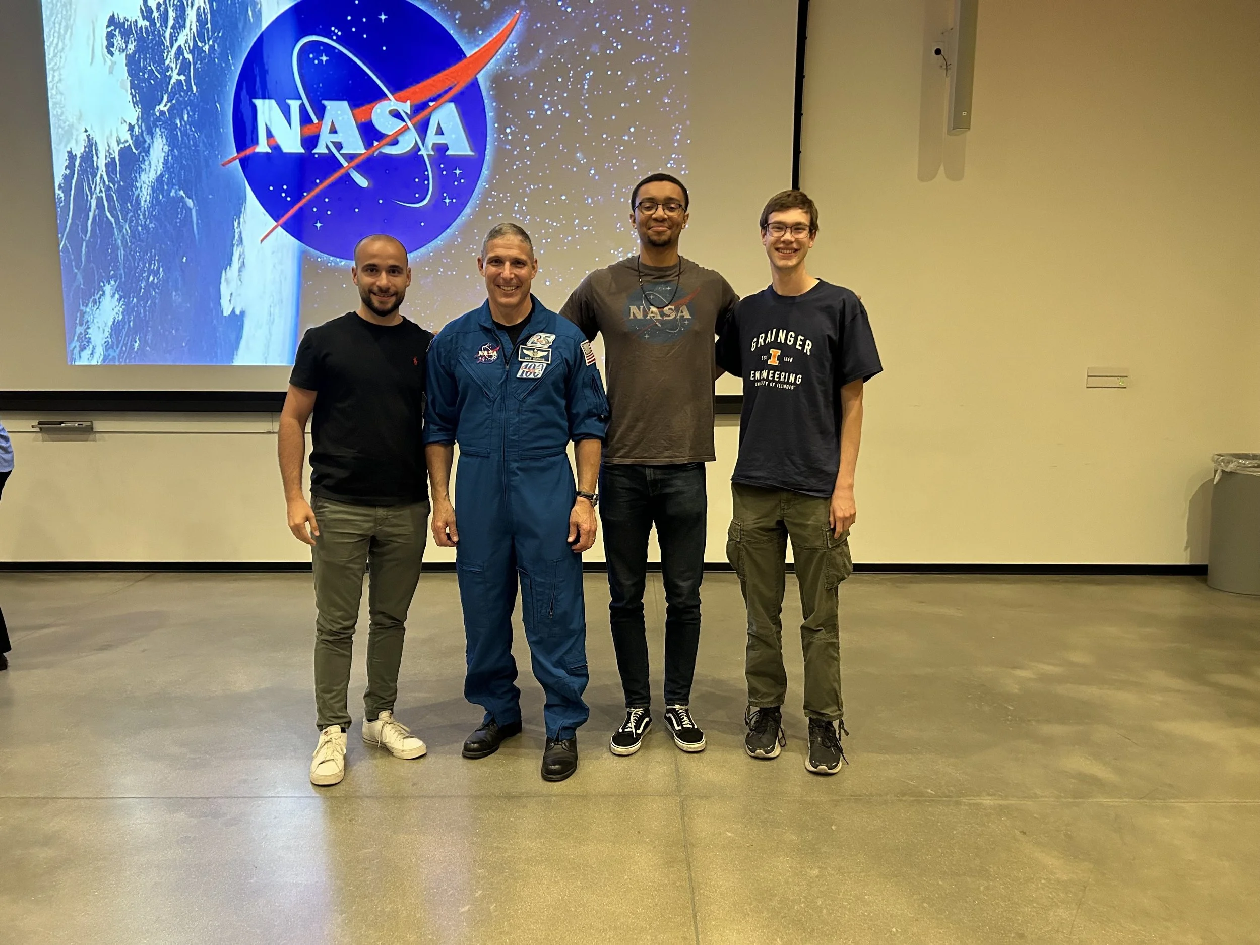Several lab students meeting astronaut