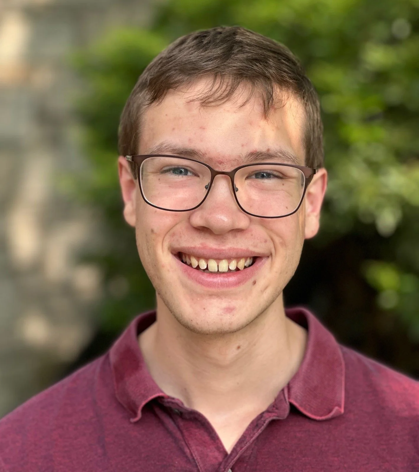 Male student with glasses and red shirt