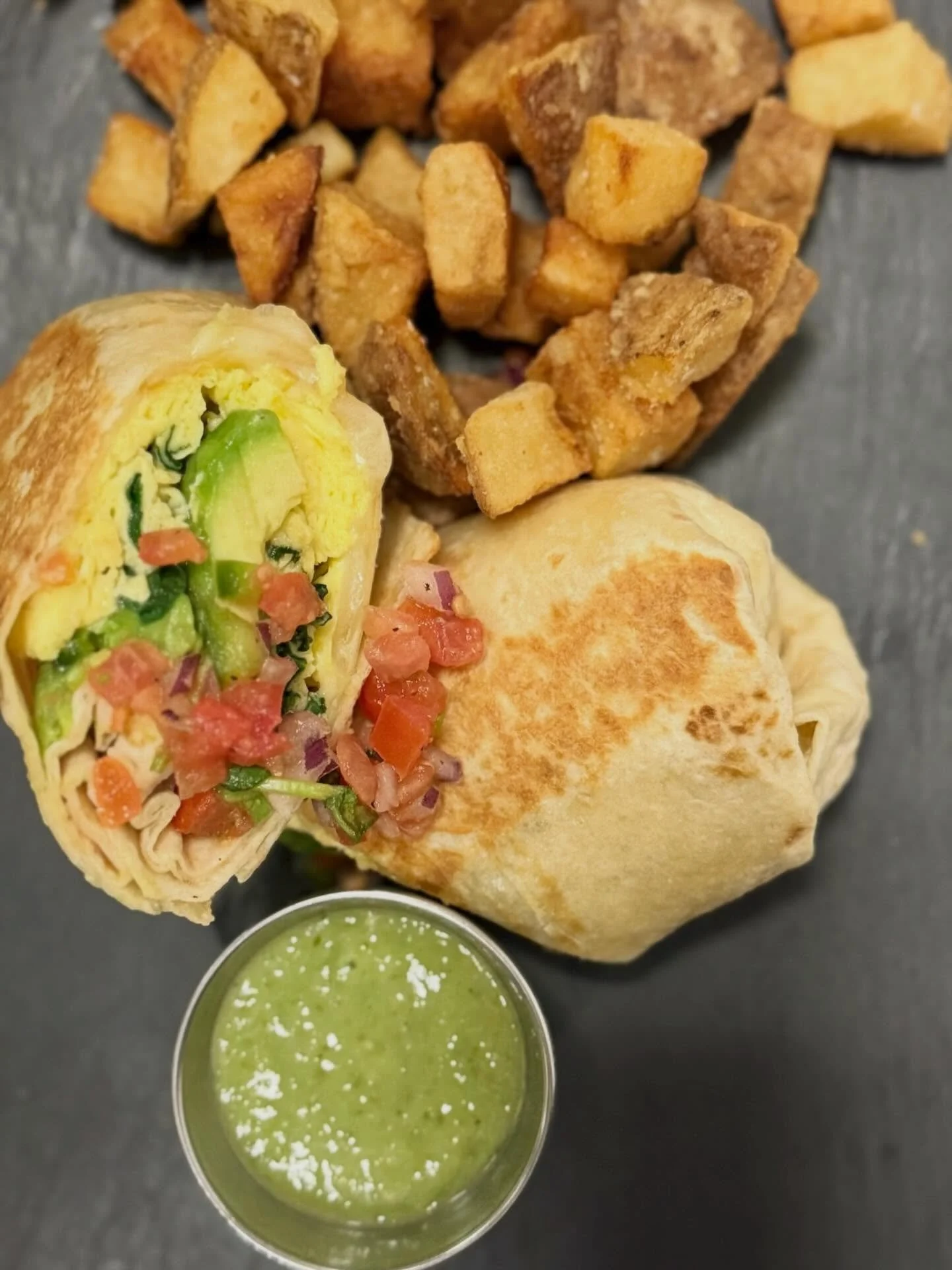 Wake up your taste buds with a breakfast burrito 🌯 {eggs, spinach, swiss cheese, avocado, pico, salsa verde}