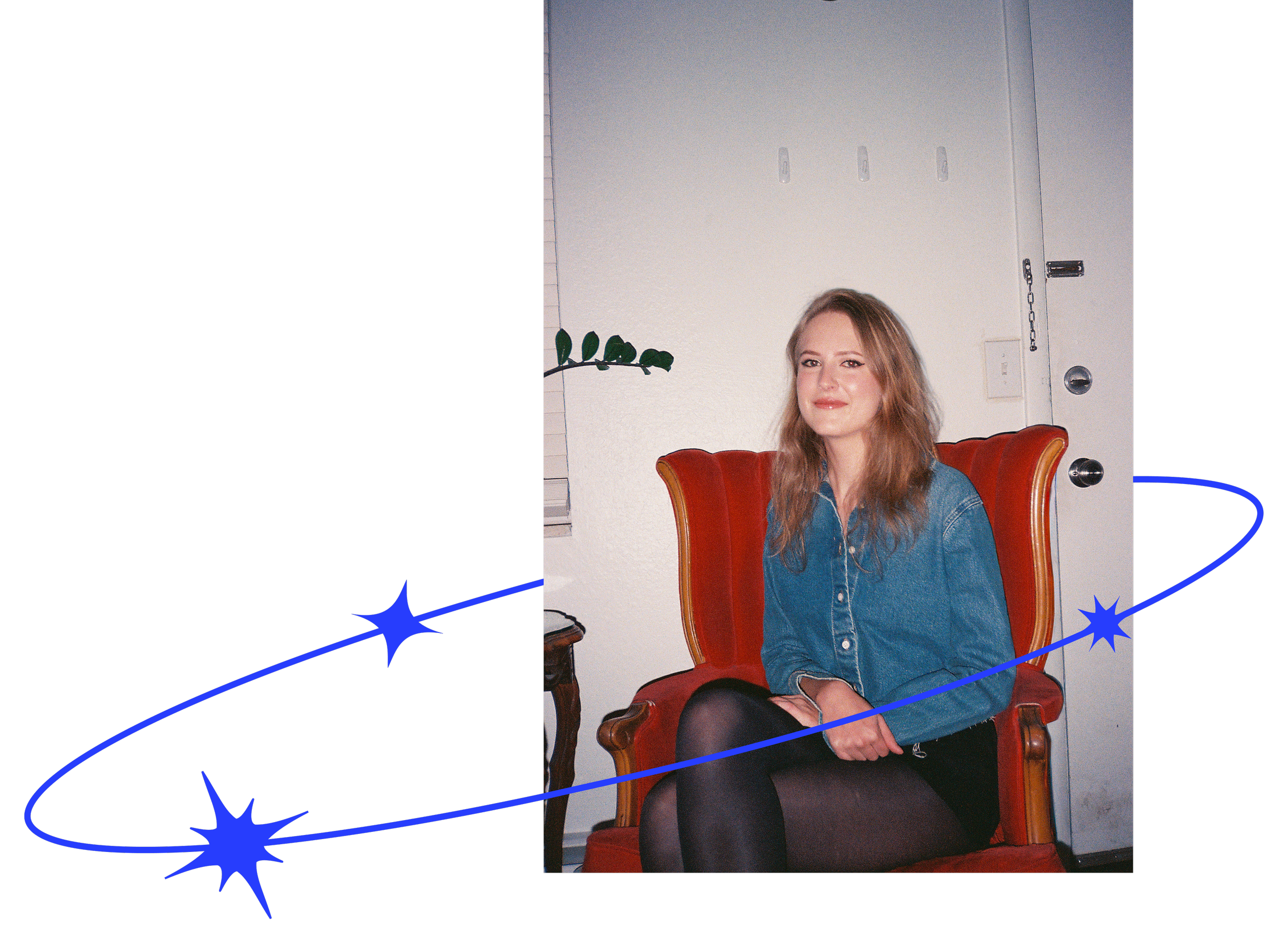 Author H.R. Birt sitting in a red chair, smiling and wearing a denim jacket.