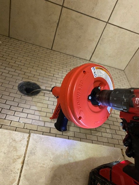 performing a drain cleaning with an auger