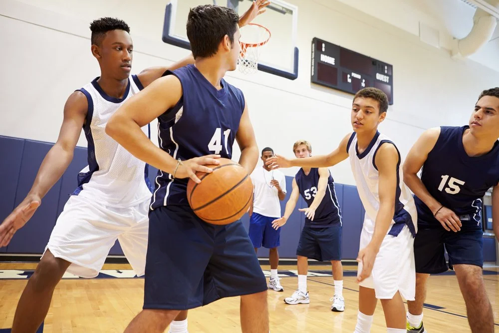 photo of boys playing basketball