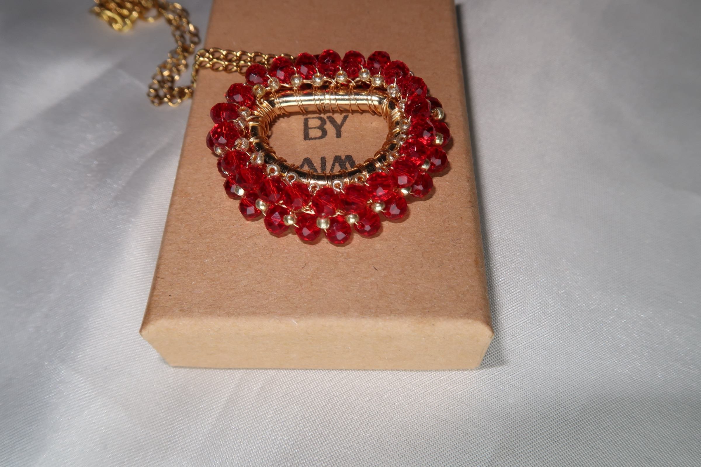 Amira-pendant-red-necklace-on-box.jpeg