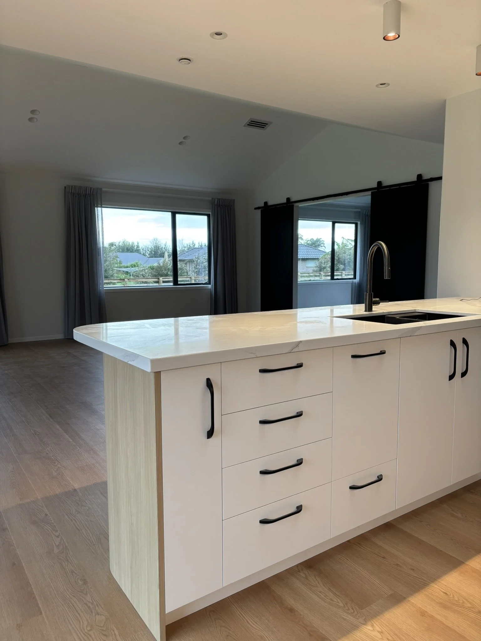 Black handles with white and timber kitchen design – Kerikeri