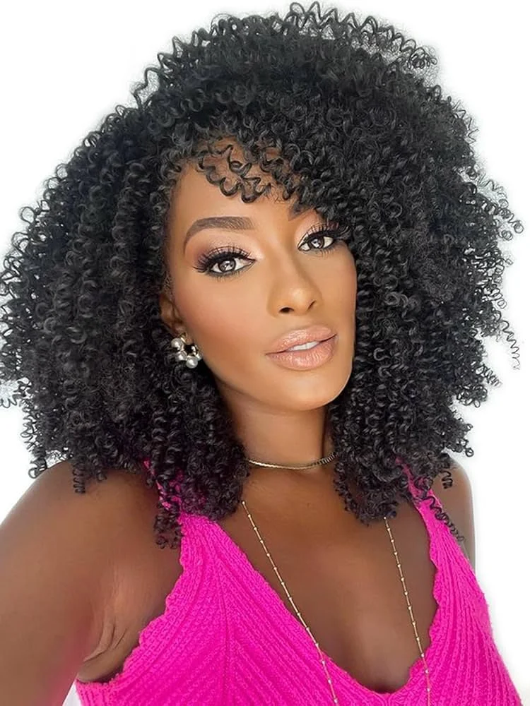 A woman with medium brown skin and voluminous tight black curly hair, wearing a pink sleeveless top, pearl earrings, a choker necklace, and a gold chain, posing for a selfie against a plain white background.