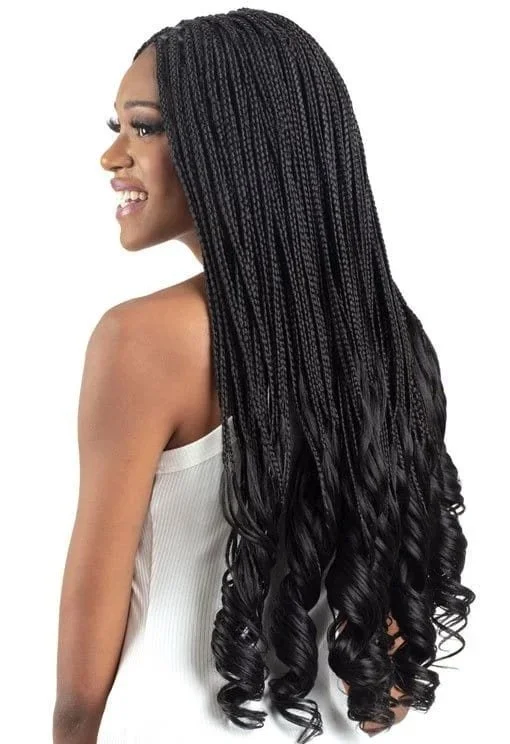 Woman with long black braided hair styled in loose curls, wearing a white tank top, smiling in profile against a white background.