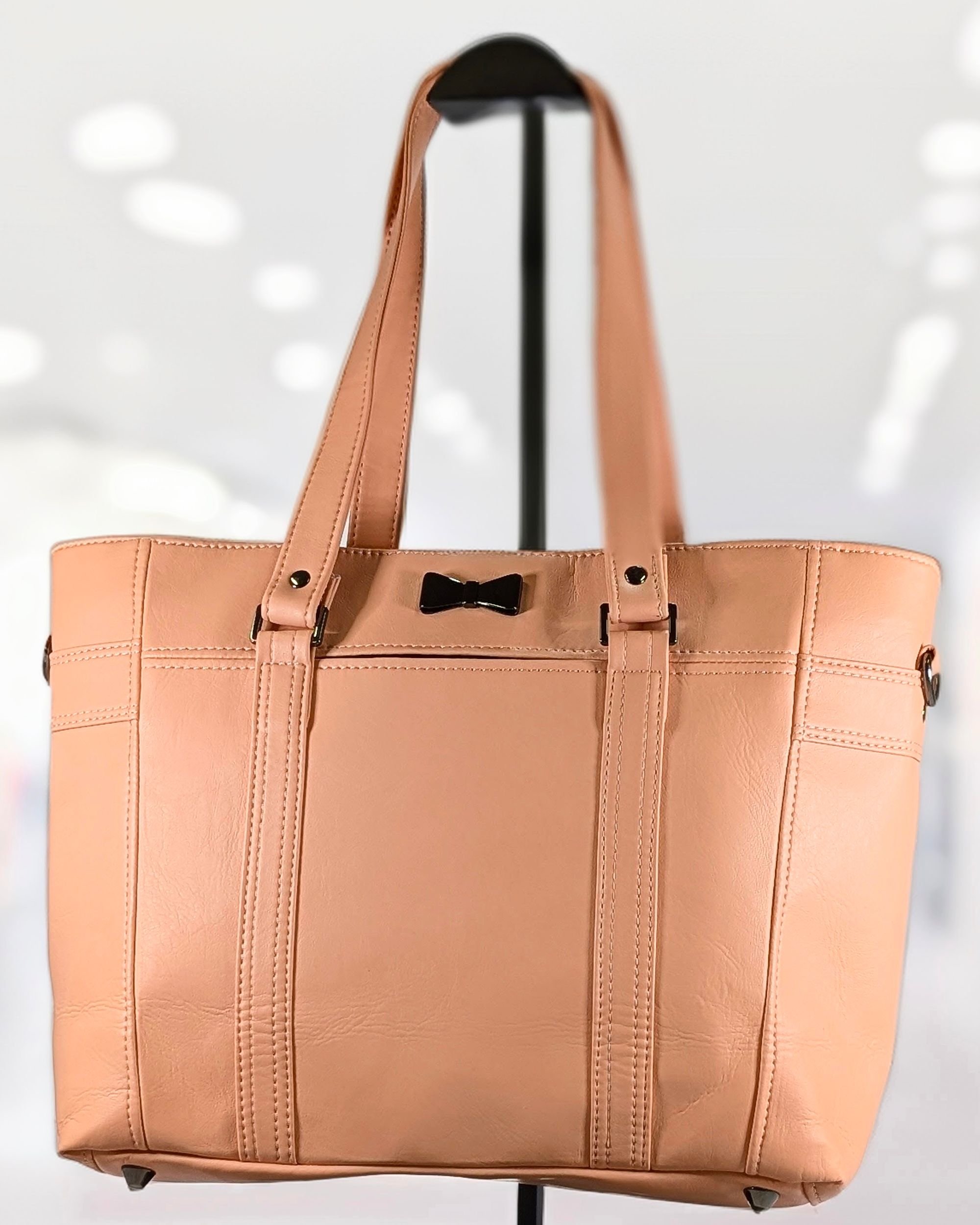 Handmade "Hearsay" tote bag with coral vinyl and an elegant metal bow highlight, crafted by Creatively Speaking Designs.