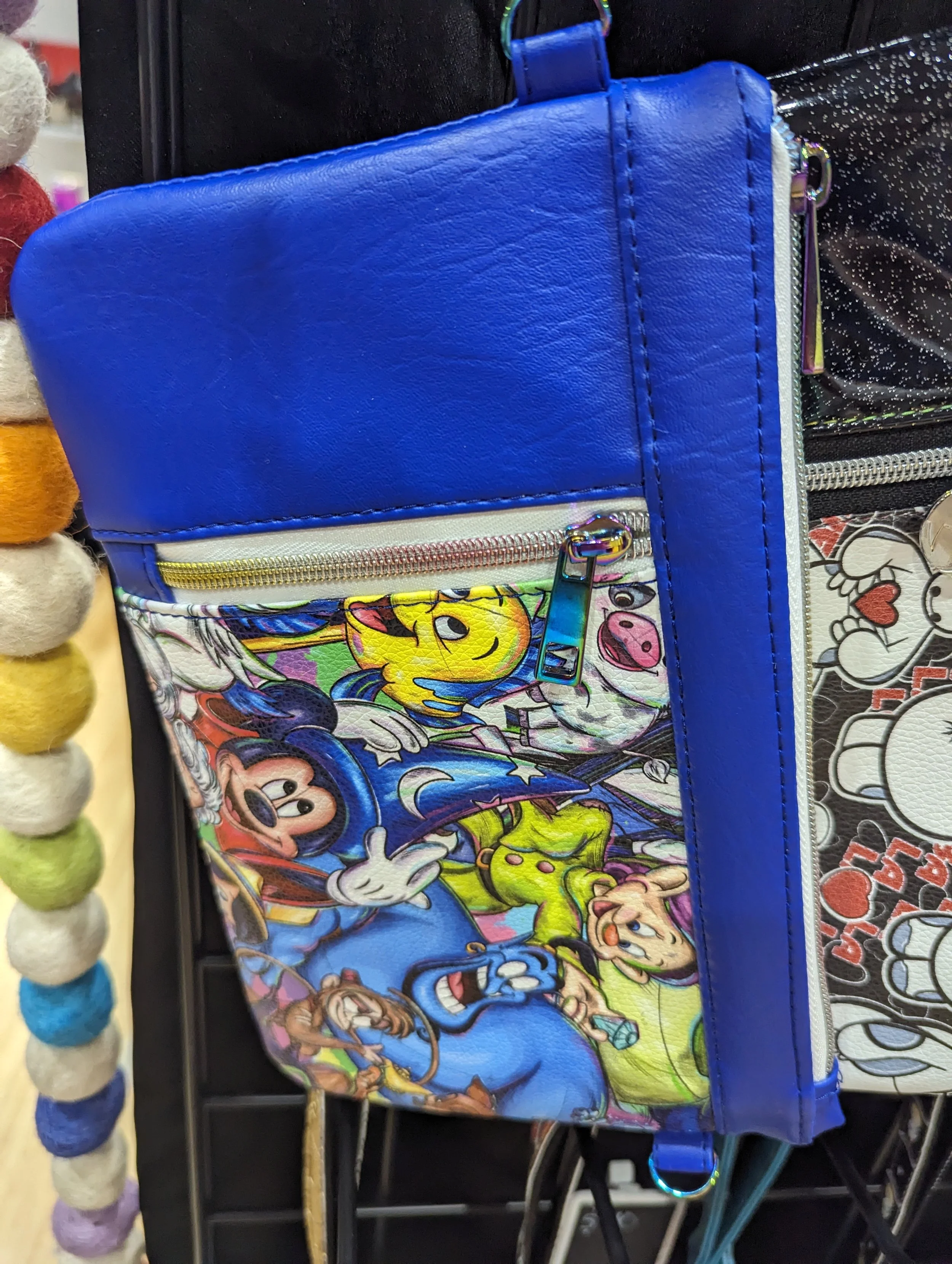 A blue backpack featuring characters from Disney's Mickey Mouse with bright colors and cartoon artwork.