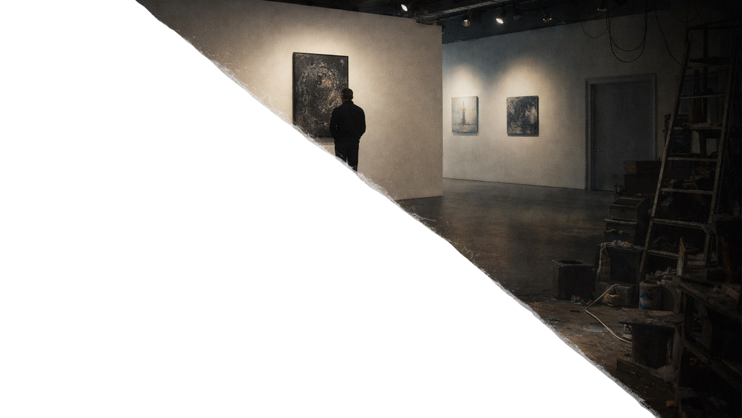 A person in dark clothing standing in an art gallery, viewing paintings on the wall to the left. The gallery has dim lighting and a dark ceiling with visible wires, and includes some shelves or storage units on the right side.