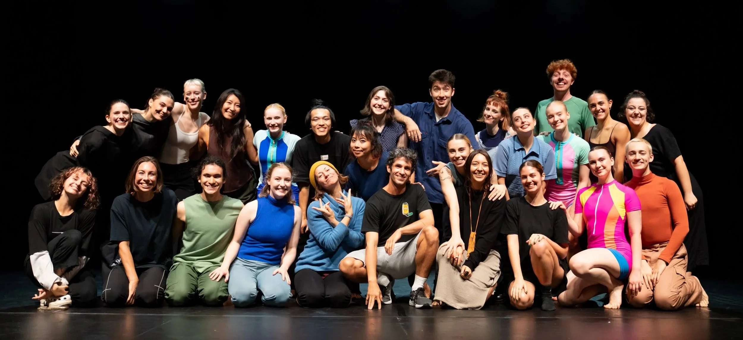 A large group of Brisbane dancers stand together in celebration