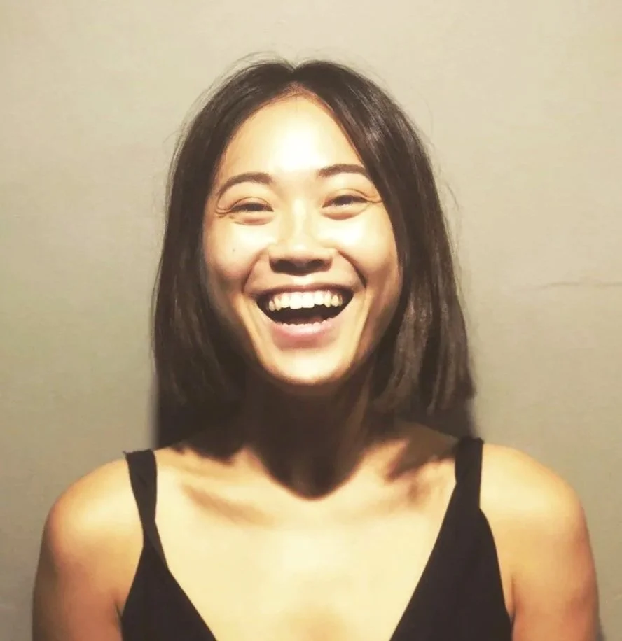 A young woman smiles with excitement