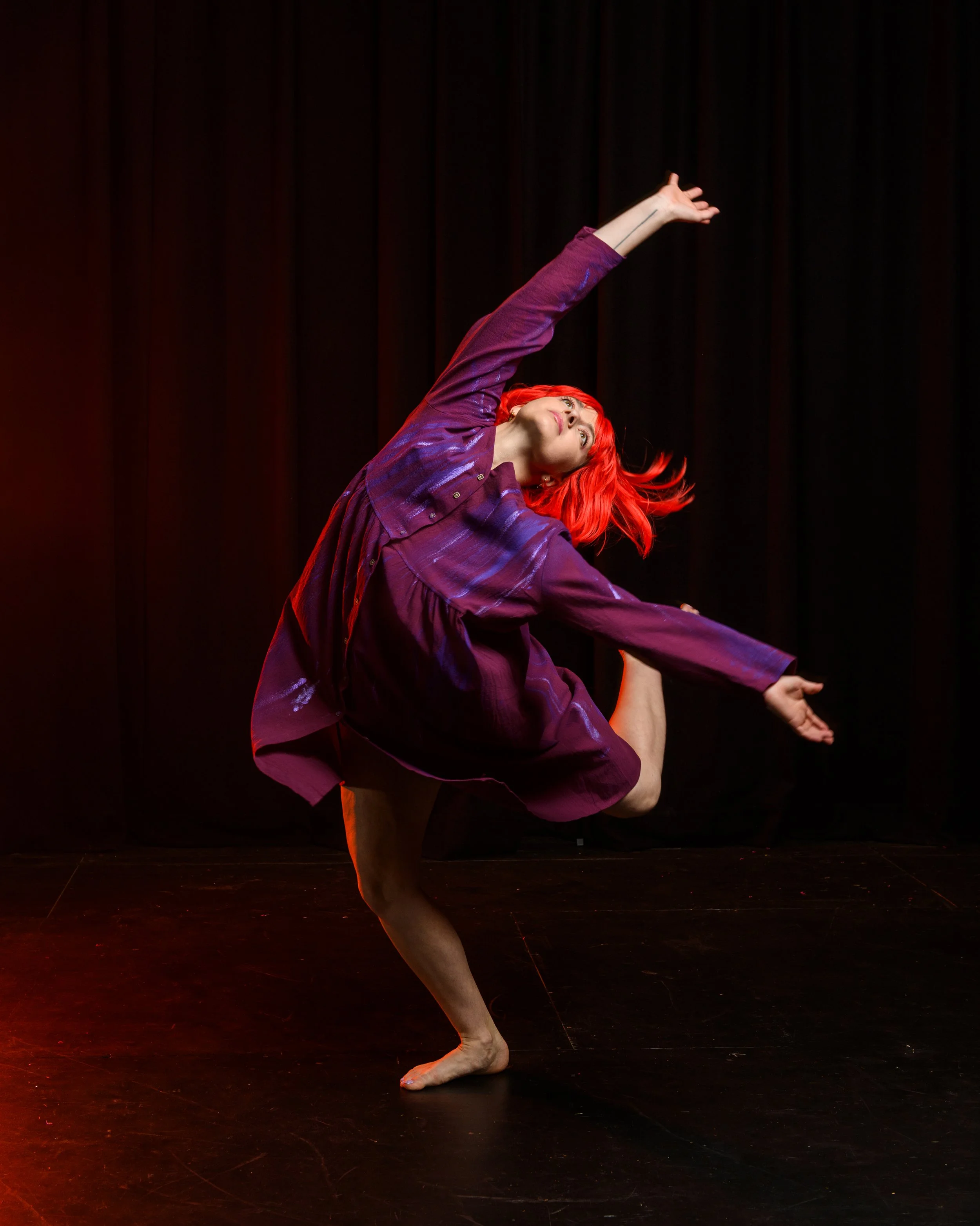 Dancer performing in spotlight with floating leaves during The Red Tree by Phluxus2 Dance Collective choreographed by Nerida Matthaei.