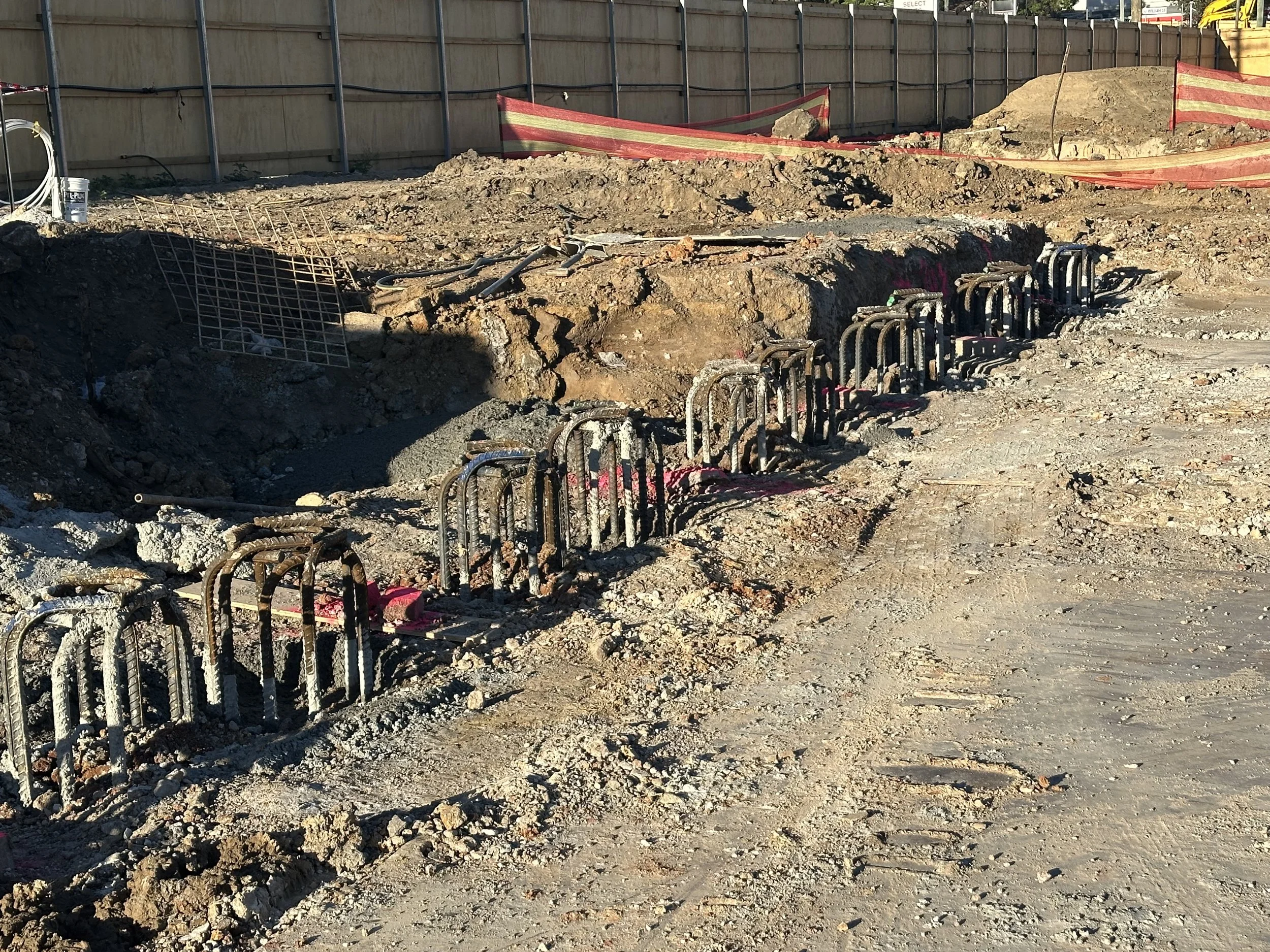 Contiguious piles, safely cordoned off with safety barriers and fencing.