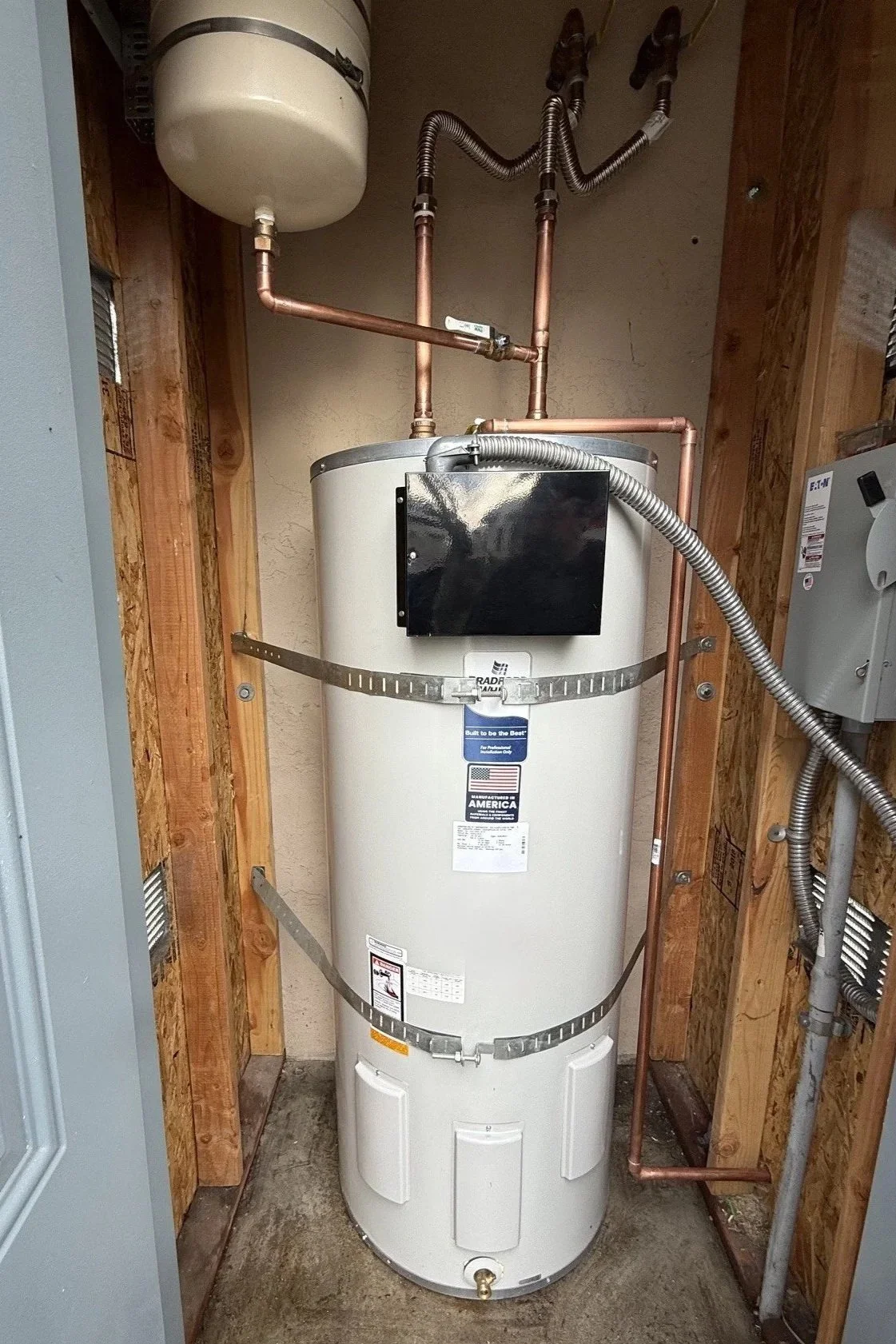 A tall white water heater