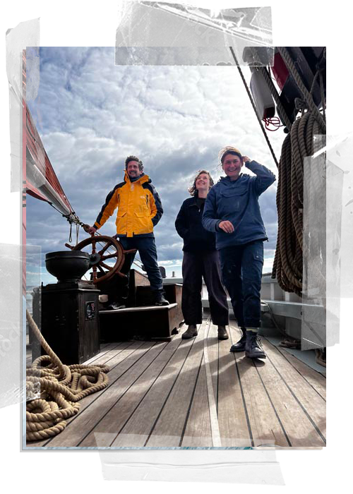 Sailing on Provident, young man on the helm