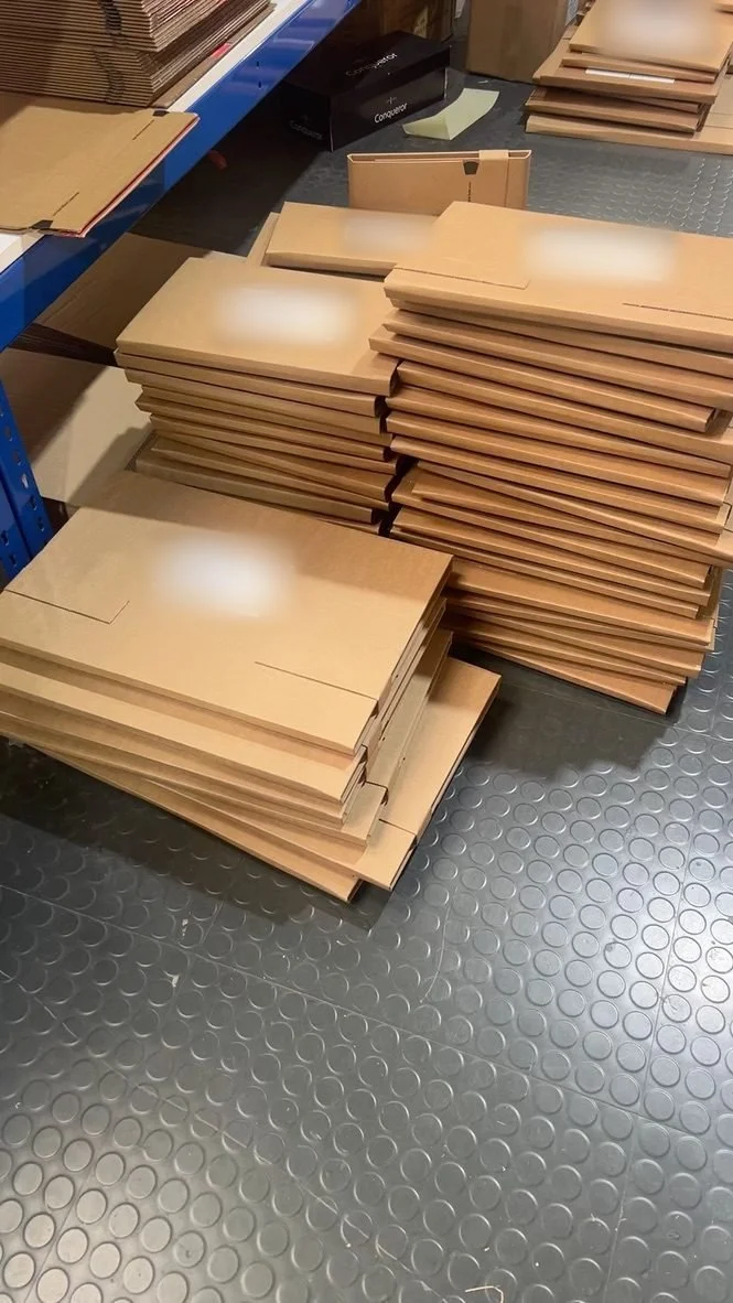Stacks of labelled print mailers ready to ship