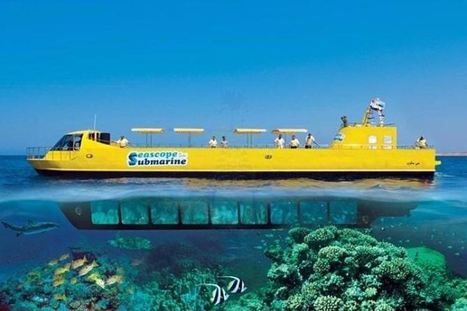 A yellow submarine named 'Seascope' floating on the ocean surface with a clear view of coral reefs and fish beneath the water.