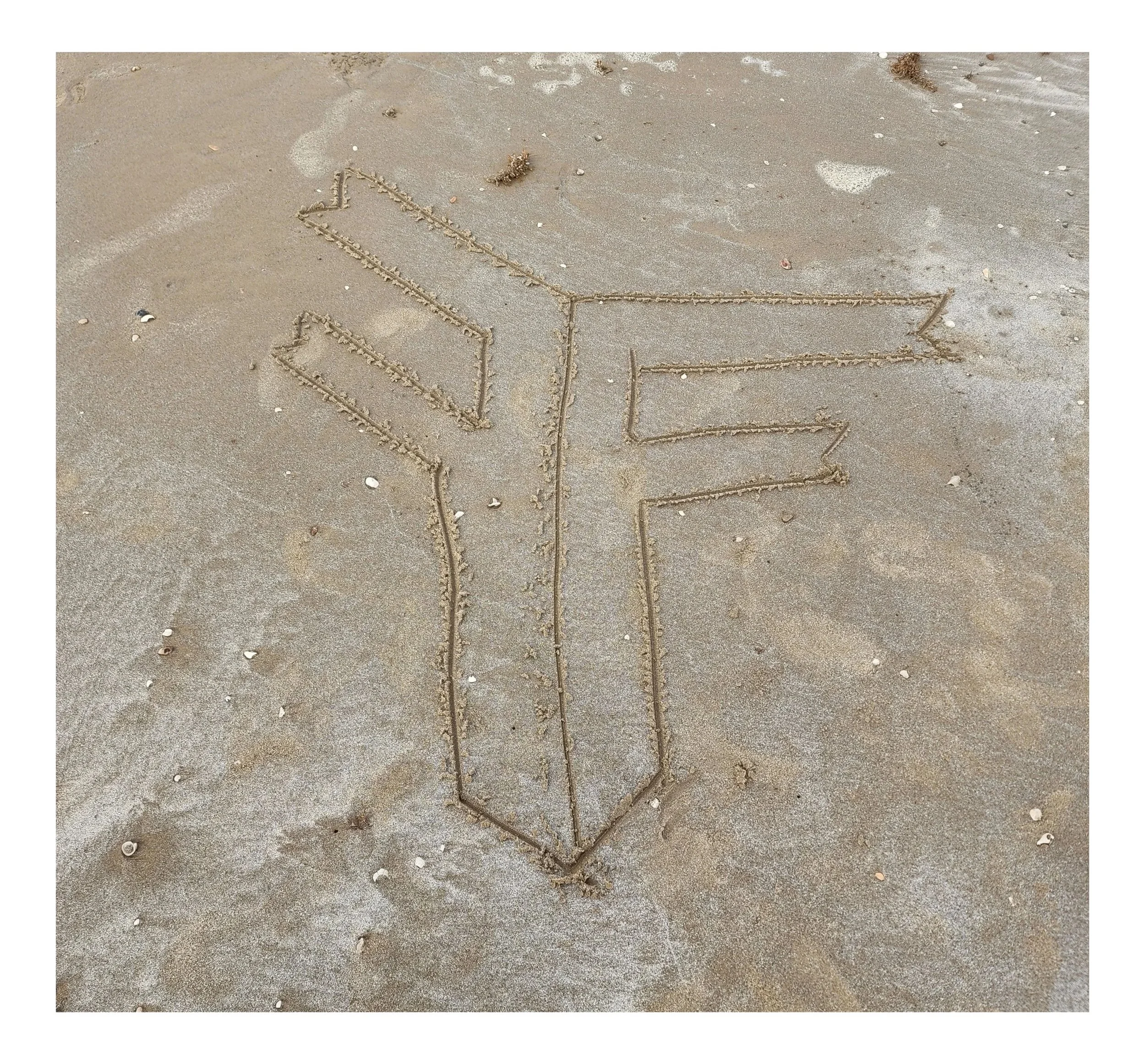 FF drawn in the sand for the first time.