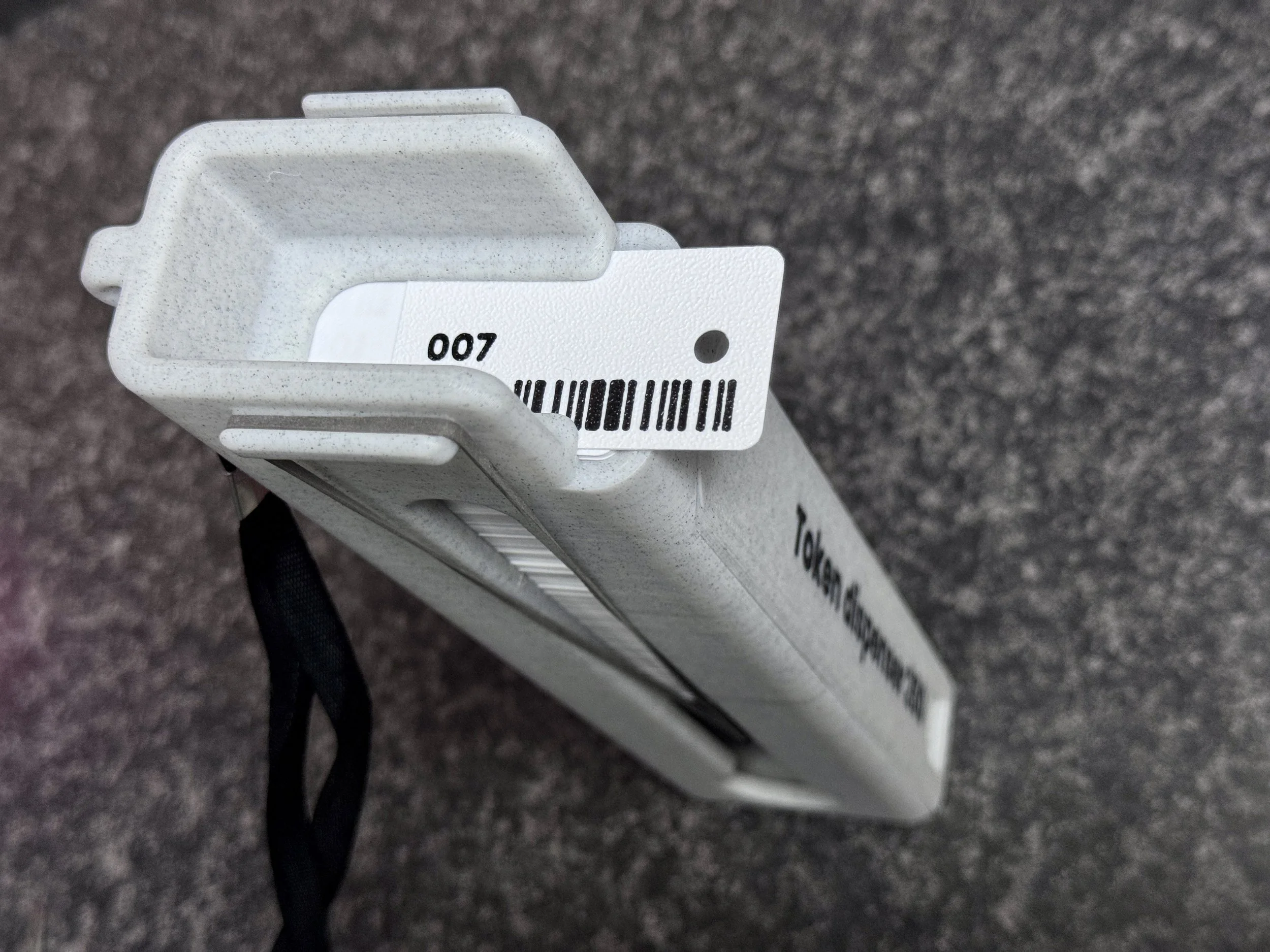 Token dispenser with token hanging out