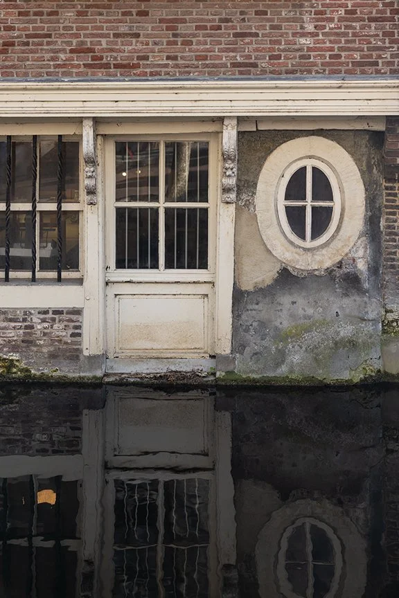 Weathered building on Voldersgracht Canal in Delft Netherlands