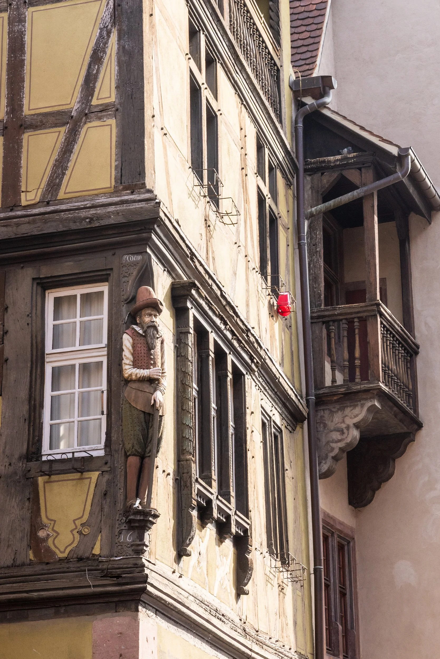 Carved merchant on the corner of Maison zum Kragen on Rue des Marchands, Colmar, France