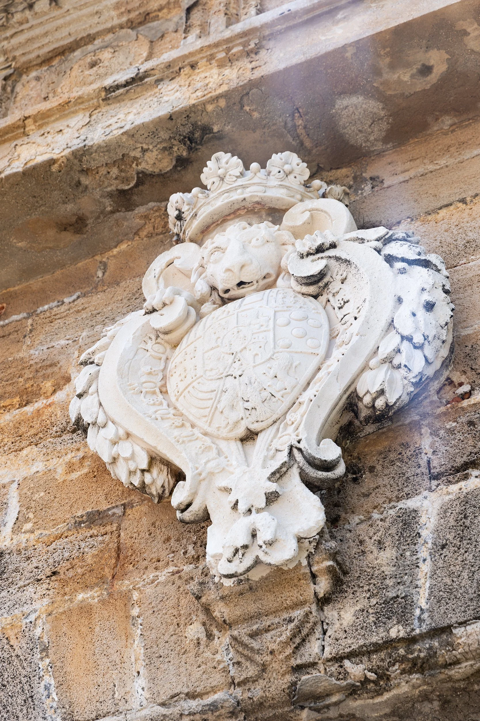 The royal coat of arms of Spain carved into the stone walls of the Castillo San Felipe del Morro, San Juan, Puerto Rico