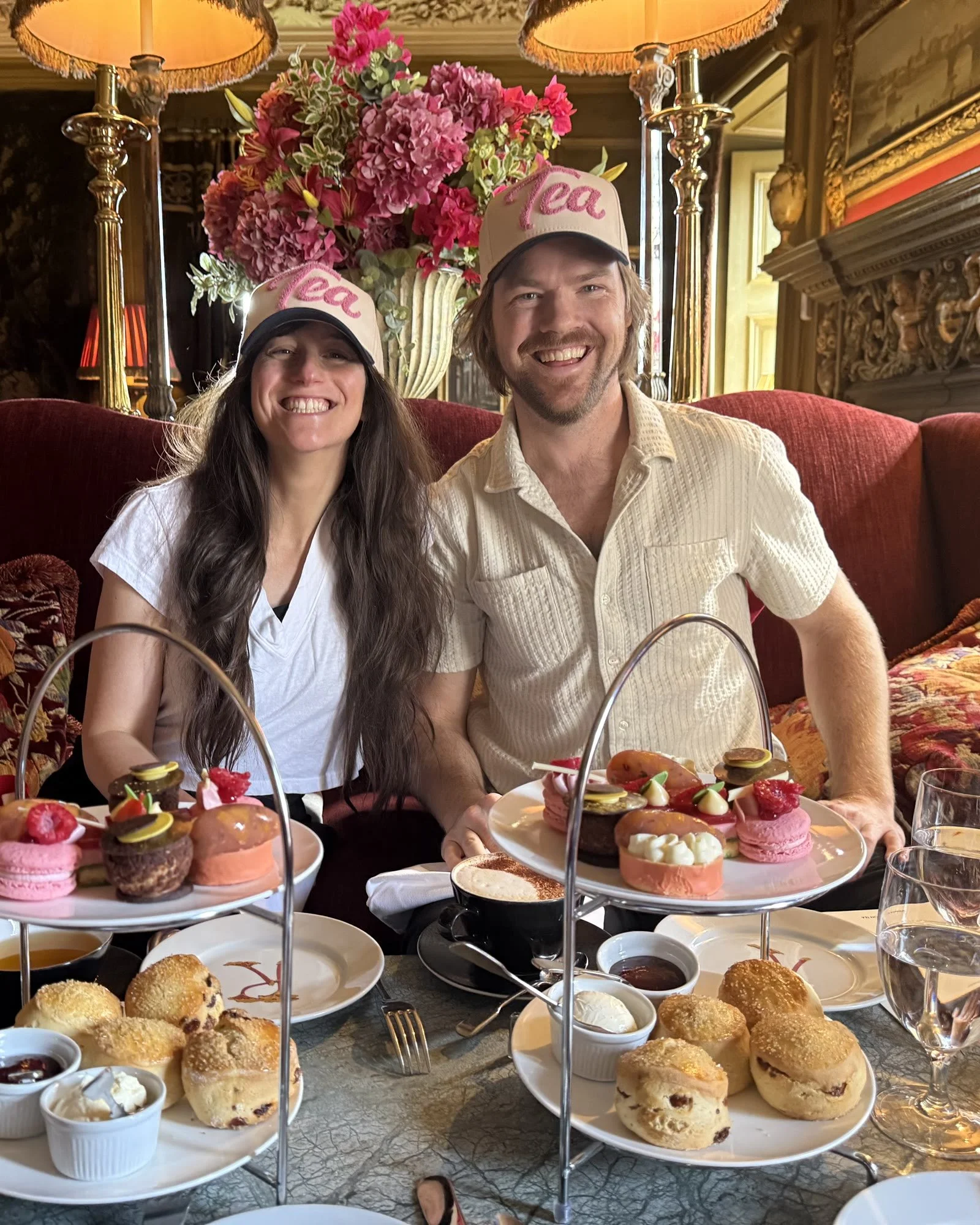 Two people wearing Tea Hats at afternoon tea