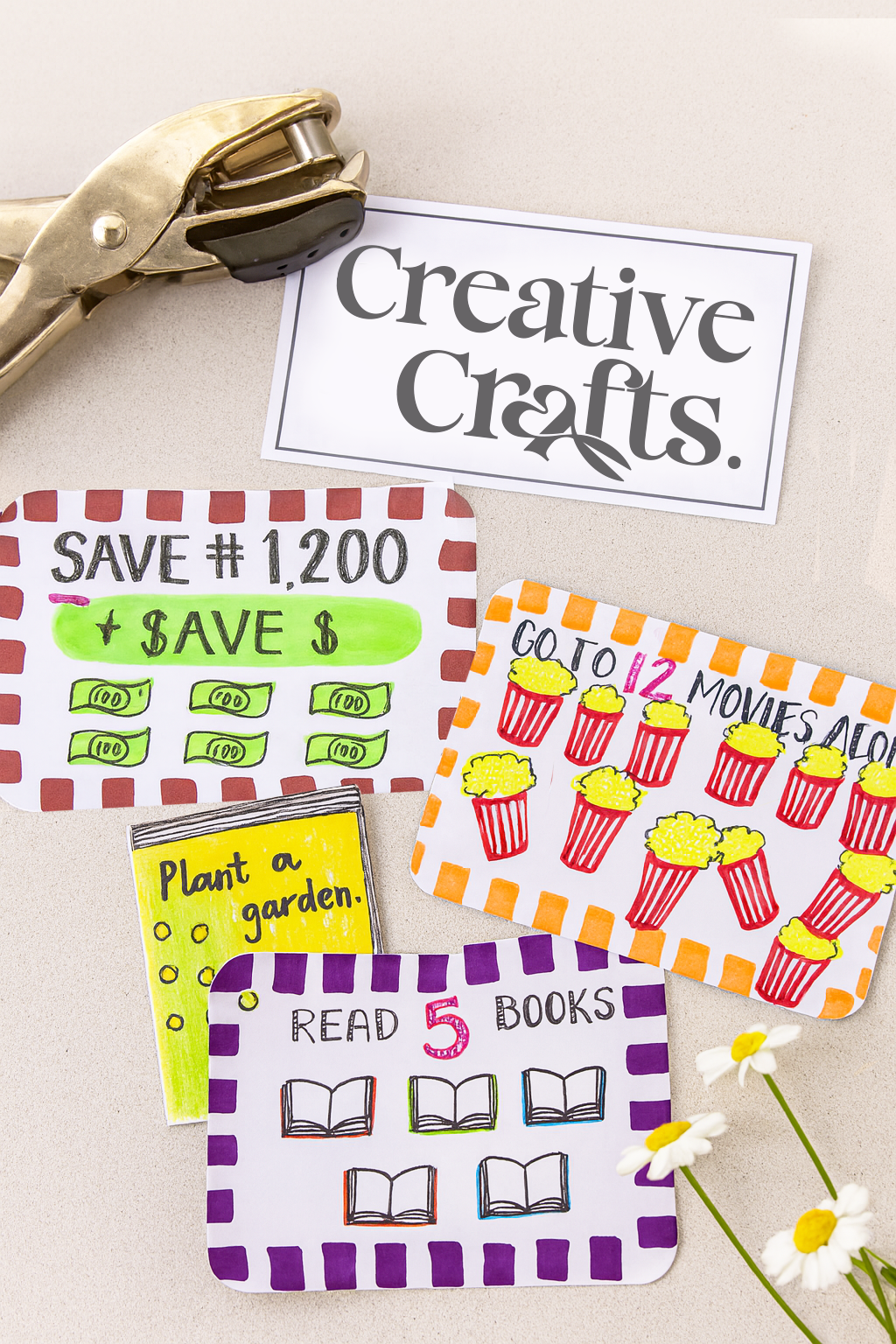 Colorful handwritten signs displaying ideas for activities and savings, along with a brass stapler and white daisies on a beige surface.