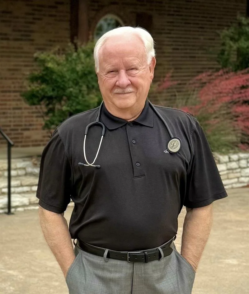 Dr. Paul Bishop, physician, standing outside The Clinic at Glen Rose wearing a stethoscope.