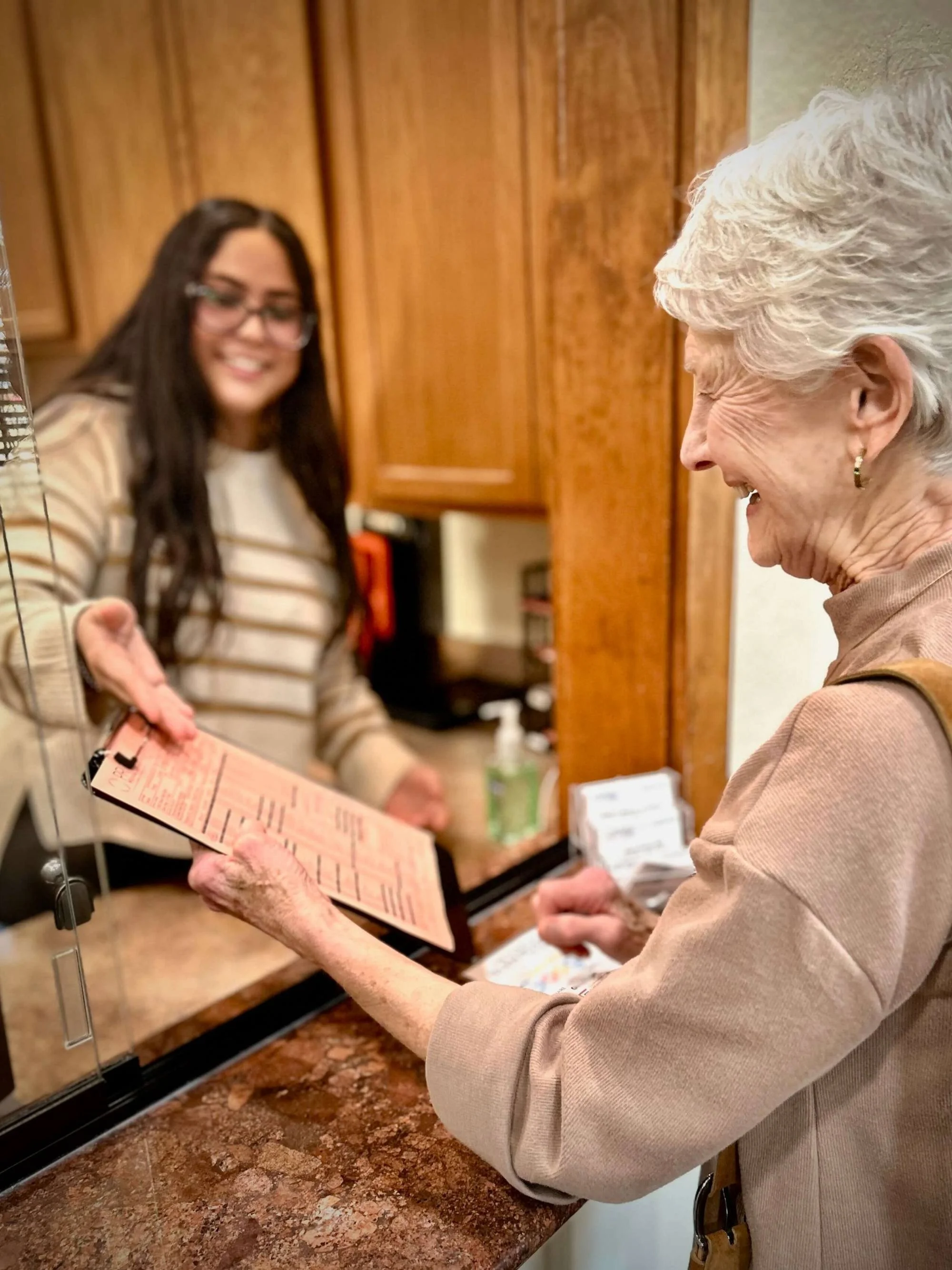 New patient checking in at the front desk at The Clinic at Glen Rose