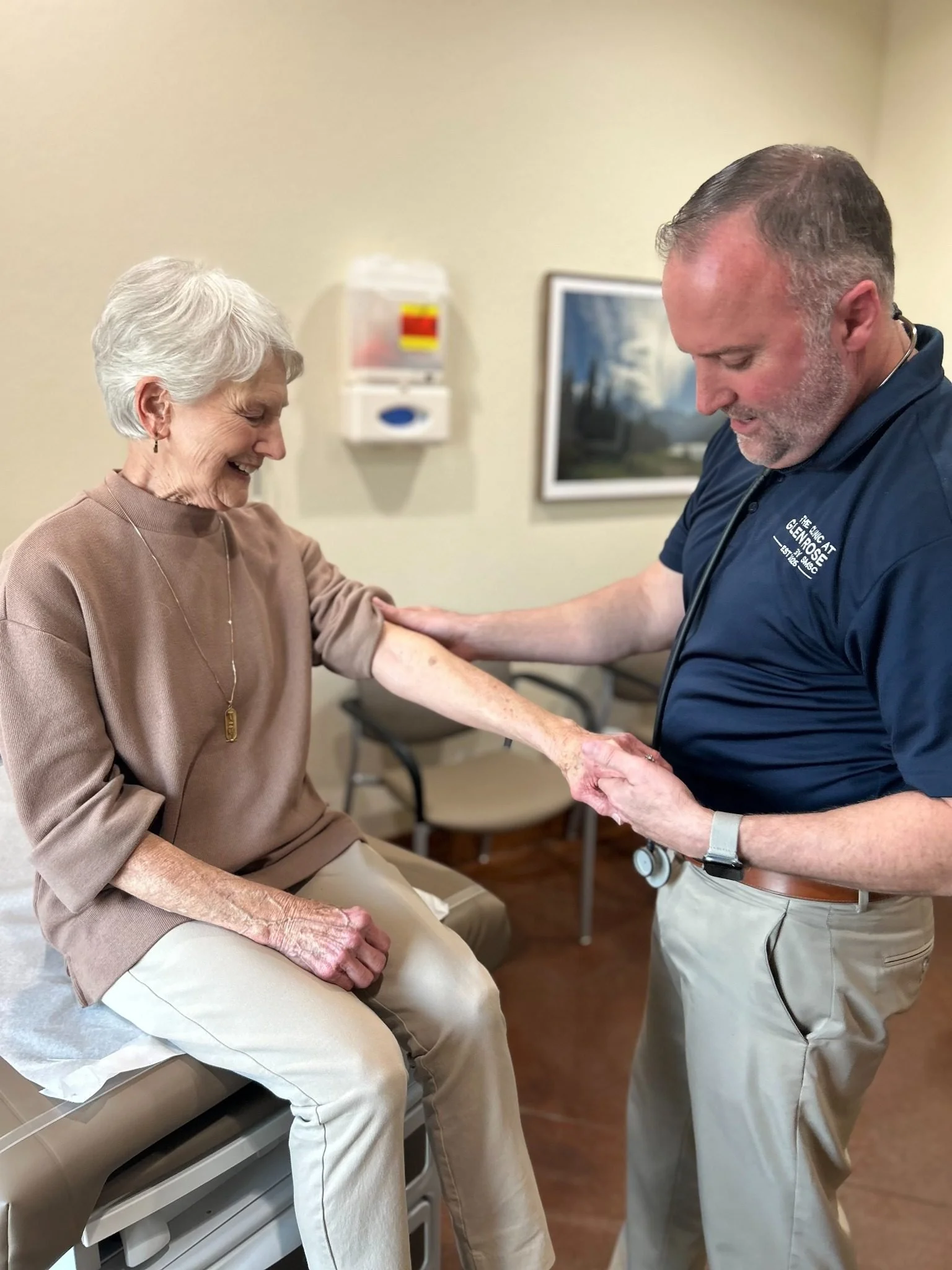 Board-certified family medicine physician evaluating a patient’s skin at The Clinic at Glen Rose in Glen Rose, Texas.