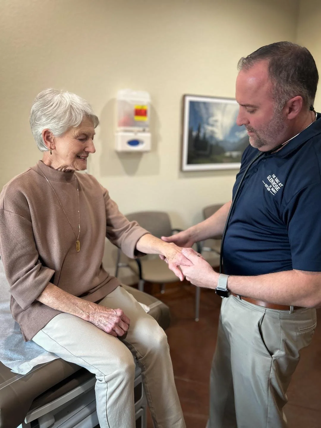 Dr. Roberts helping an elderly patient at The Clinic at Glen Rose