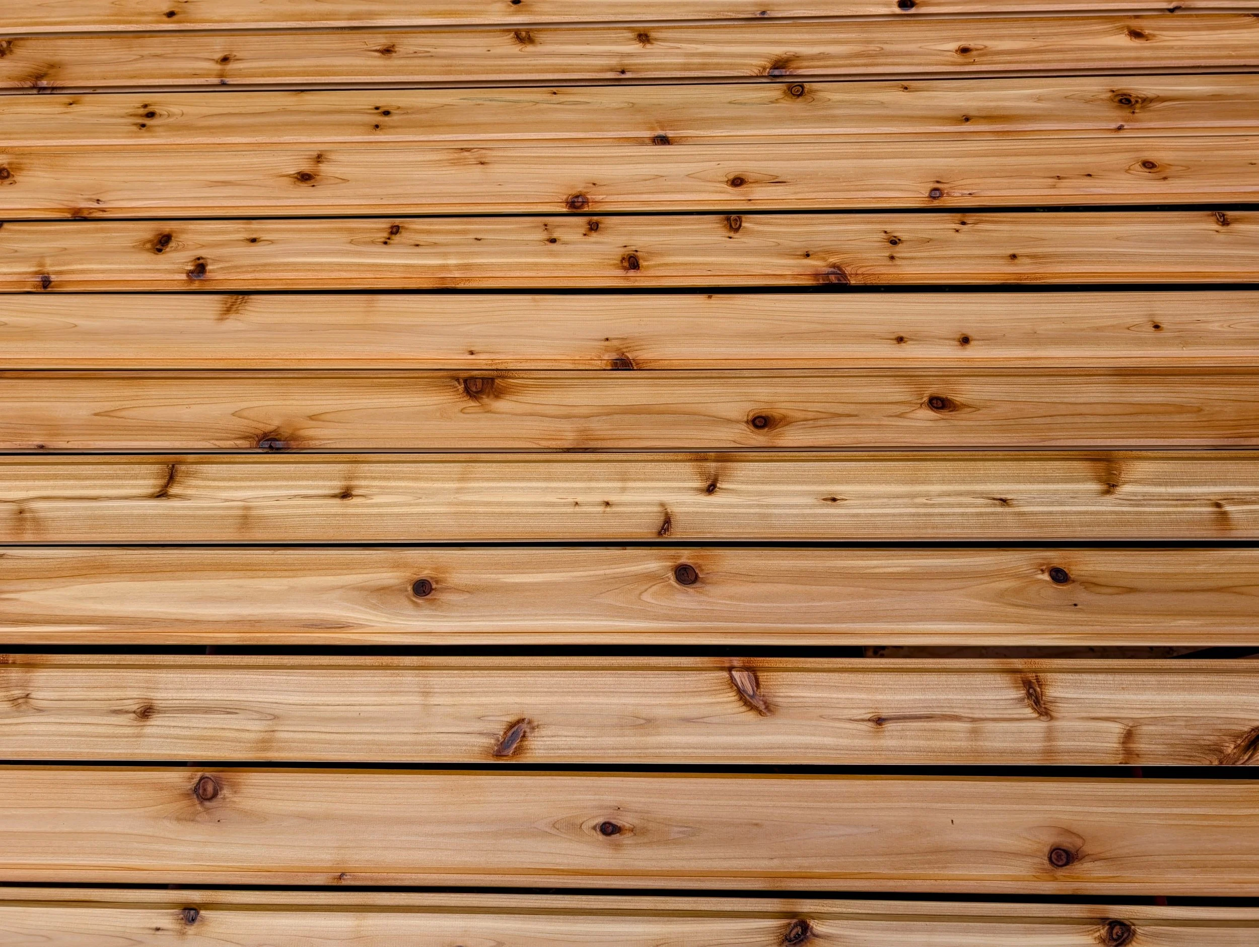 Close-up view of horizontal wooden planks with visible knots and natural wood grain.